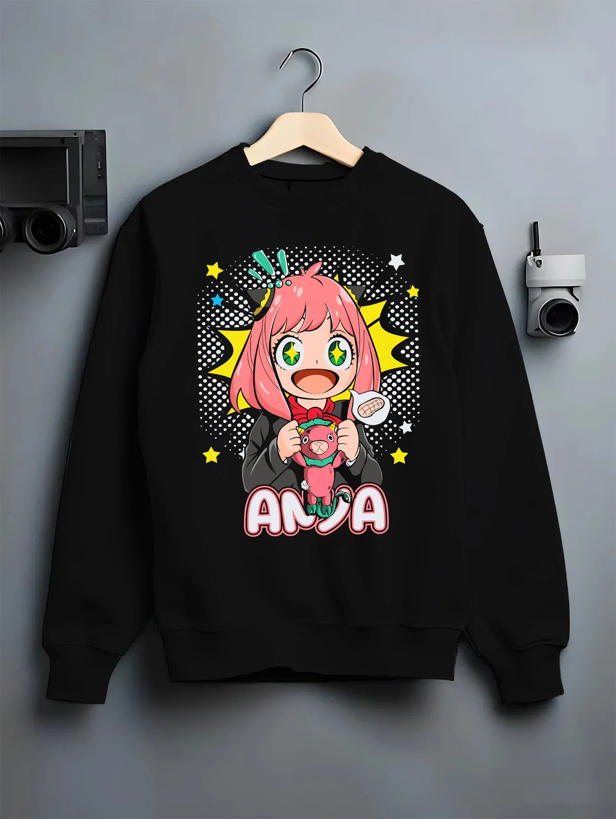 Black crewneck sweatshirt on hanger with Anya Forger from Spy x Family illustrated back graphic