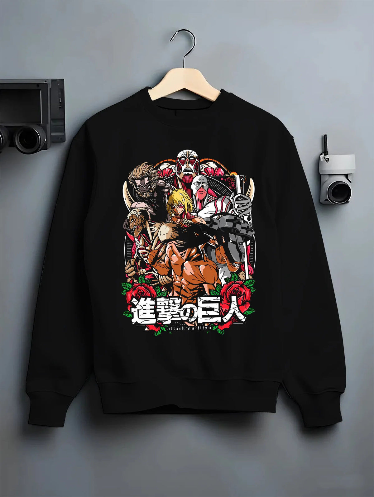 Black crewneck sweatshirt on hanger showing Attack on Titan: character and Titan group artwork