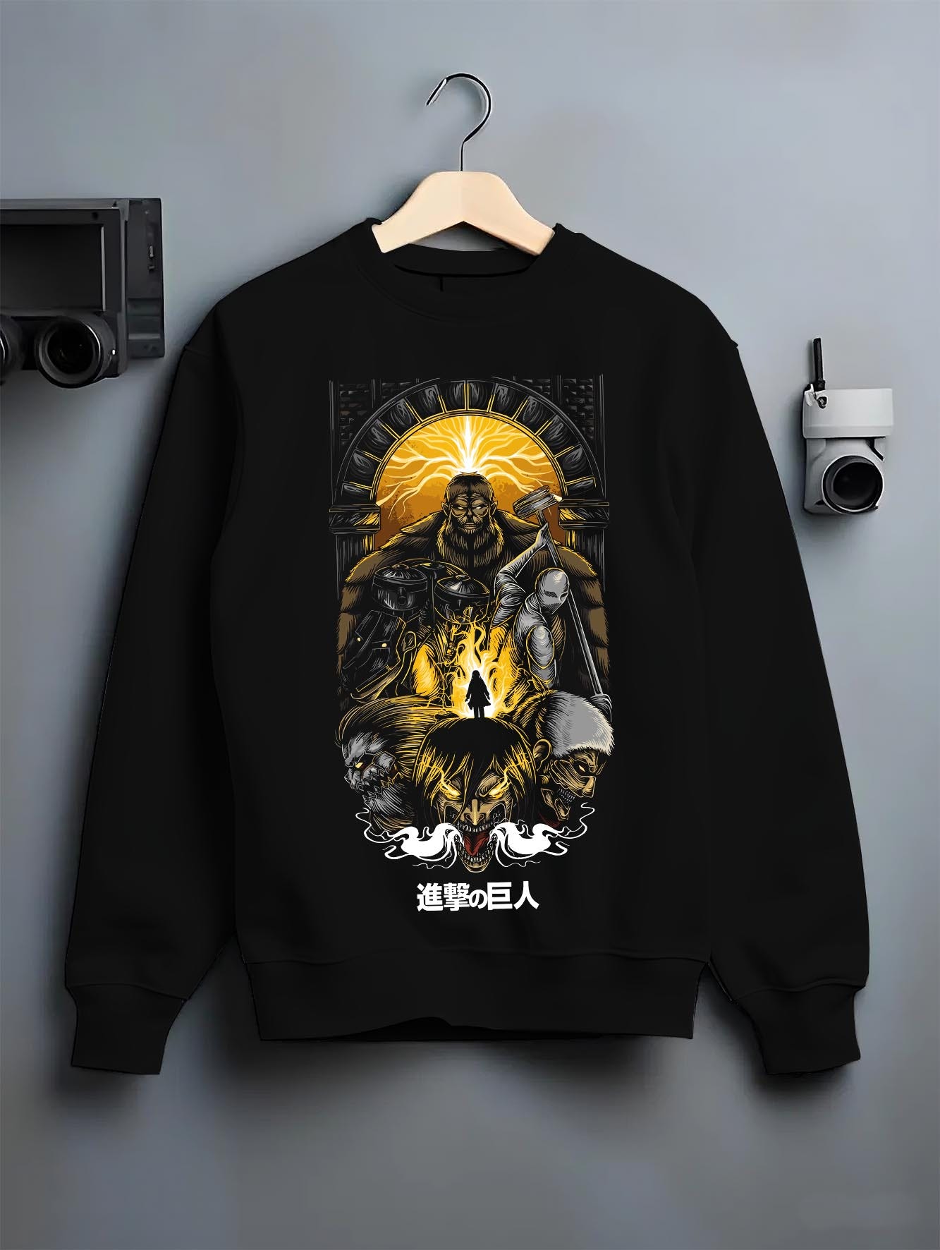 Black crewneck sweatshirt on a hanger against a grey wall, featuring Attack on Titan anime poster inspired design with retro manga artwork print and dystopian anime aesthetic.