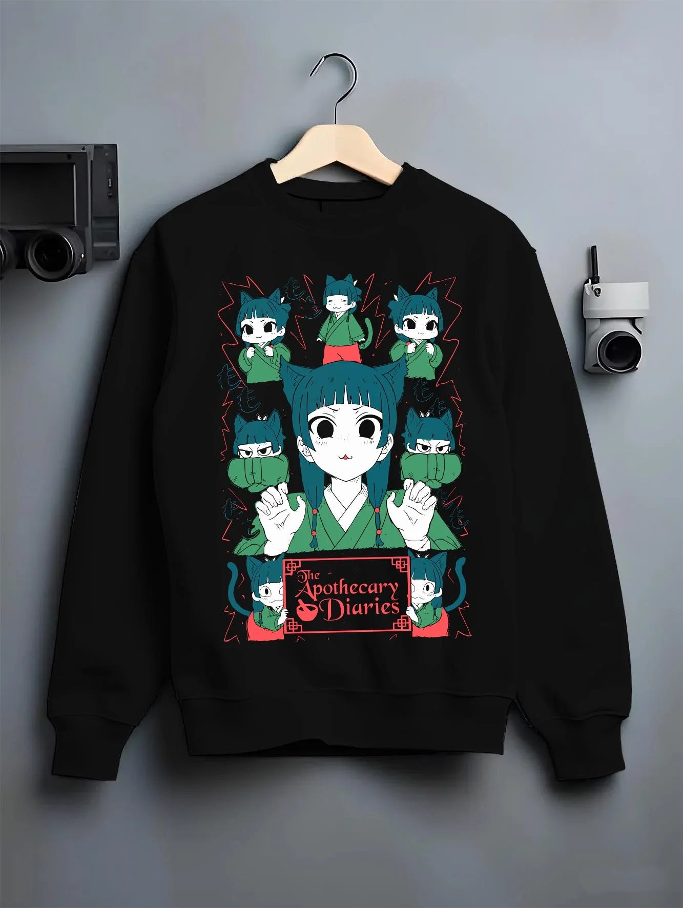 Black crewneck sweatshirt on hanger with Apothecary Diaries Hoodie Maomao Green Poison Dolls graphic premium wear.