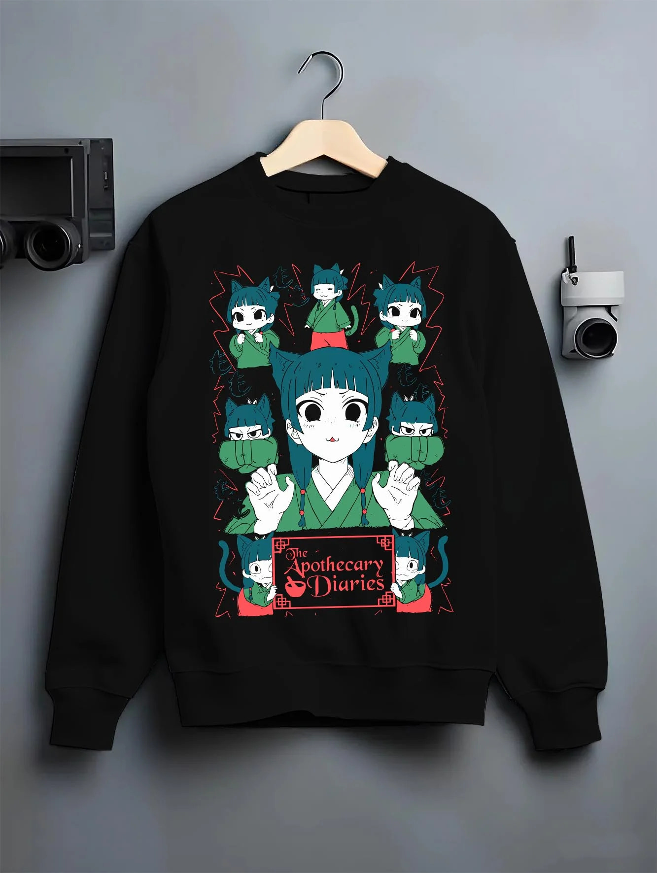Black crewneck sweatshirt on hanger with Apothecary Diaries Hoodie Maomao Green Poison Dolls graphic premium wear.