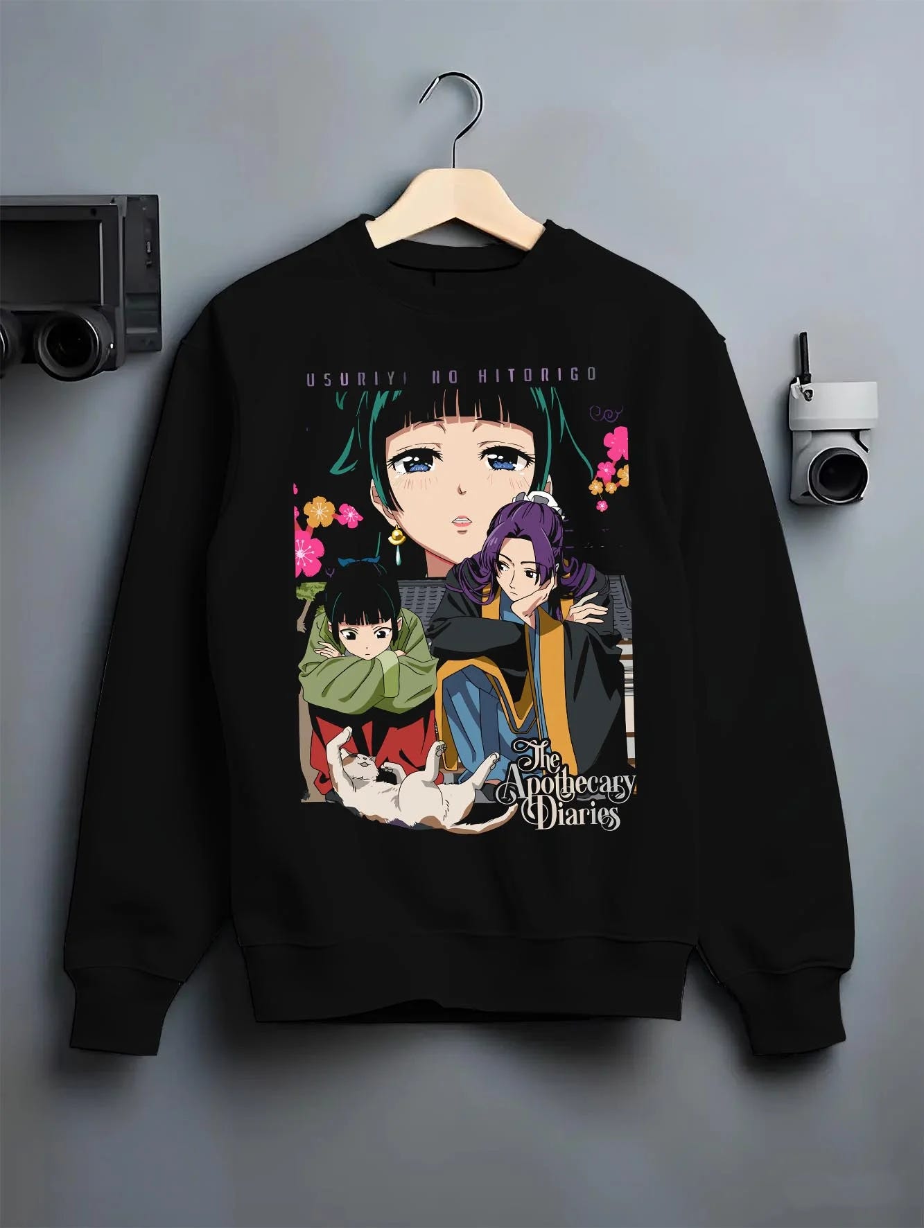 Black crewneck sweatshirt on hanger with Apothecary Diaries Hoodie Jinshi and Maomao Duo Scene graphic streetwear graphic.