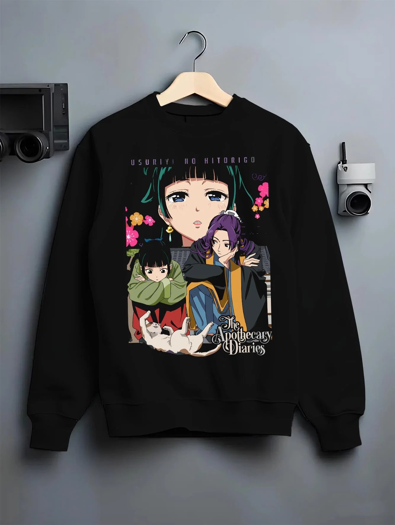 Black crewneck sweatshirt on hanger with Apothecary Diaries Hoodie Jinshi and Maomao Duo Scene graphic streetwear graphic.