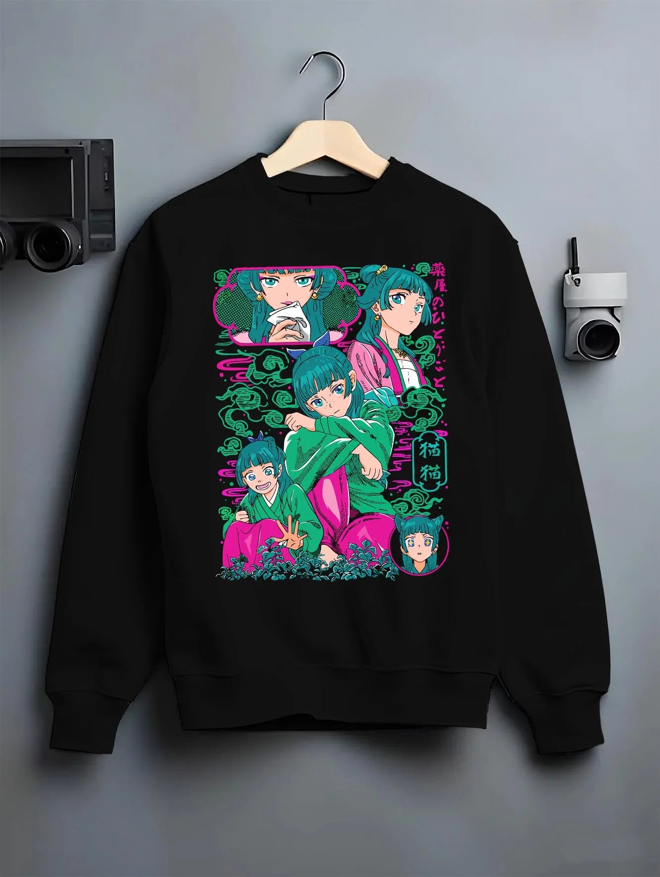 Black crewneck sweatshirt on hanger with Apothecary Diaries Hoodie Maomao Pink Hair Trio Panel graphic bold anime graphic.