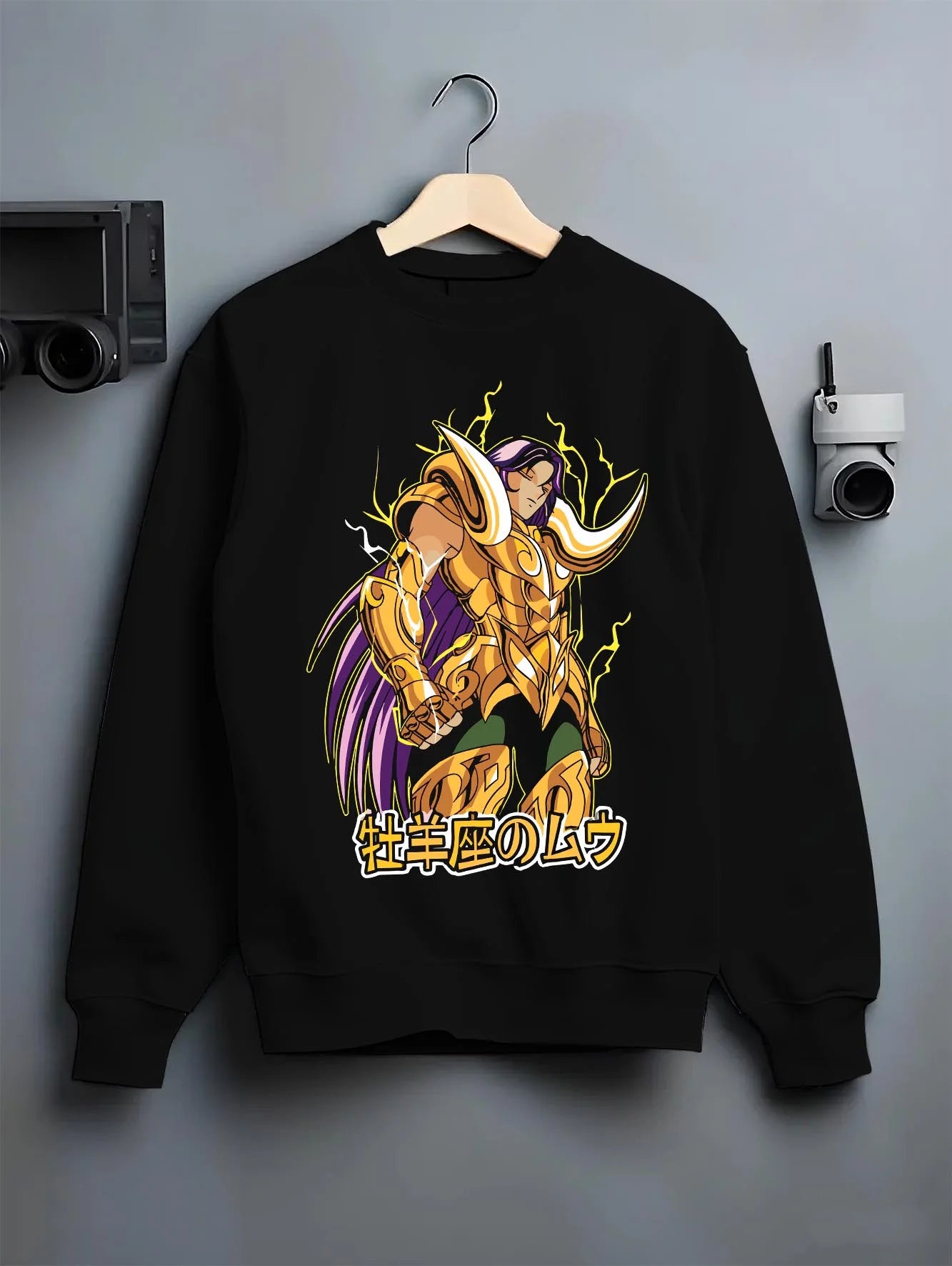 Black crewneck sweatshirt on hanger with Aries Gold Saint Hoodie Saint Seiya Cloth Armour Battle graphic streetwear graphic.