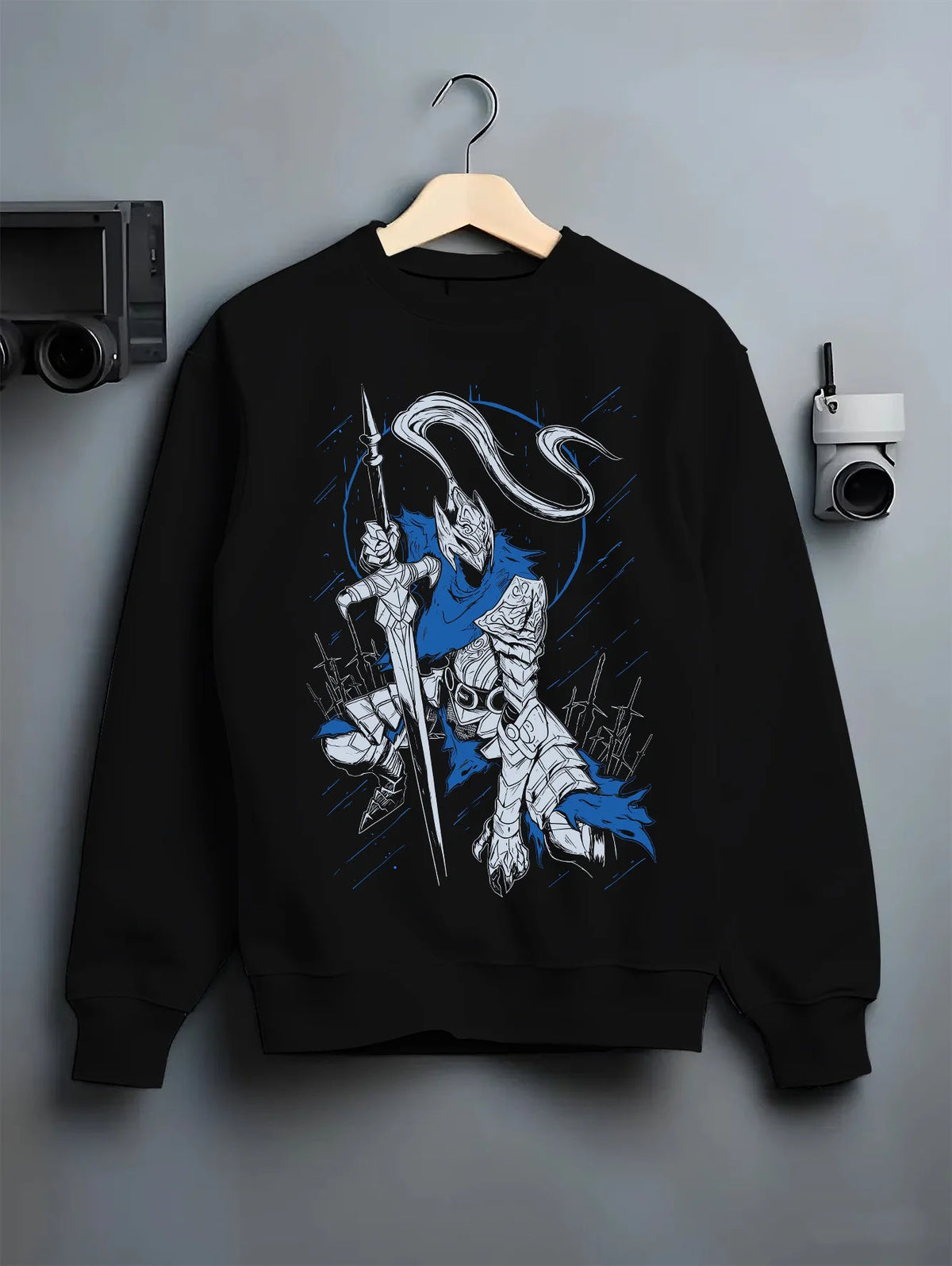 Black crewneck sweatshirt on hanger showing Artorias the Abysswalker from Dark Souls: armoured swordsman carrying a longsword