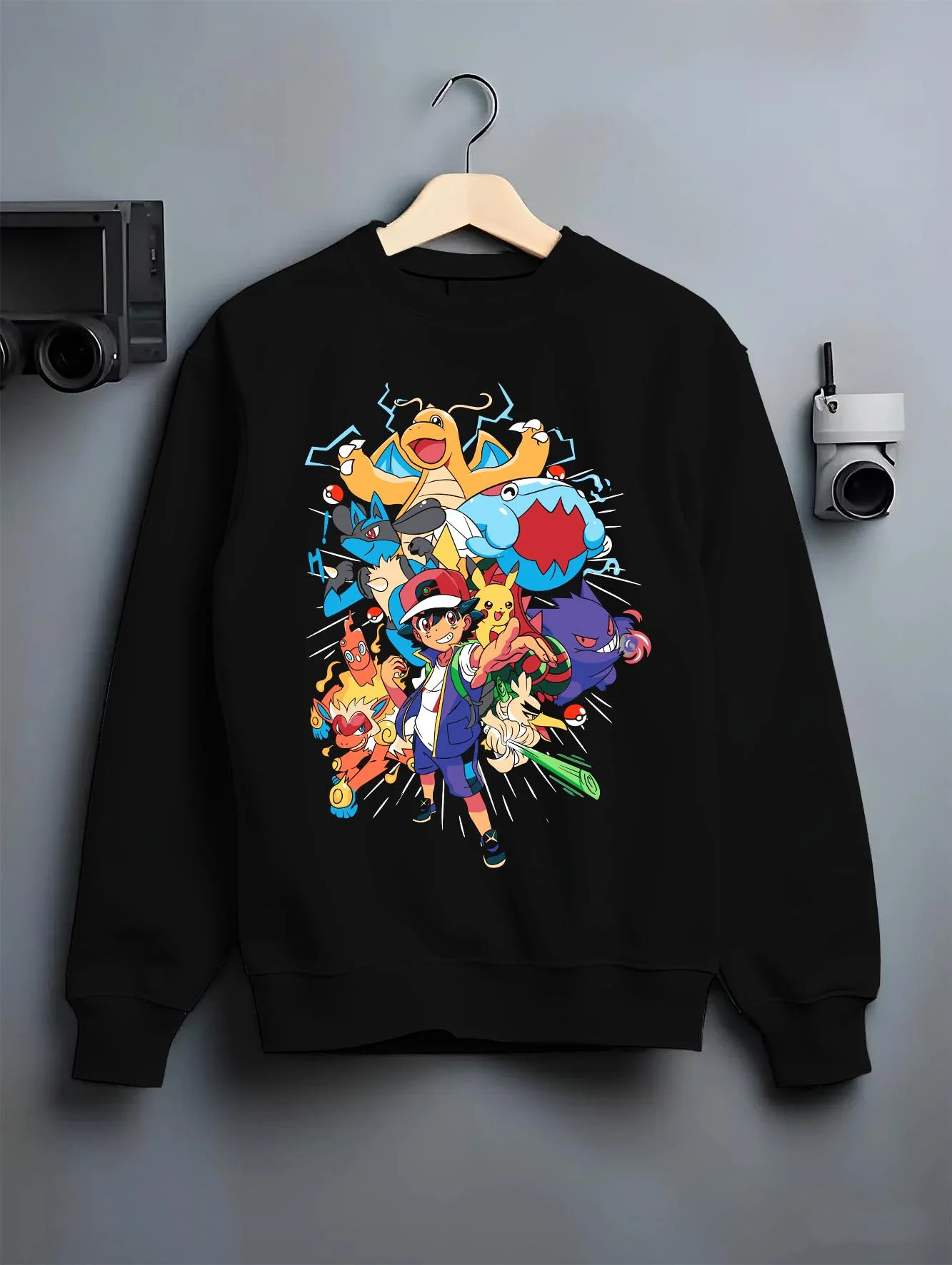 Black crewneck sweatshirt on hanger with Ash and Pikachu Hoodie Pokémon Retro Anime Team Pose graphic premium wear.
