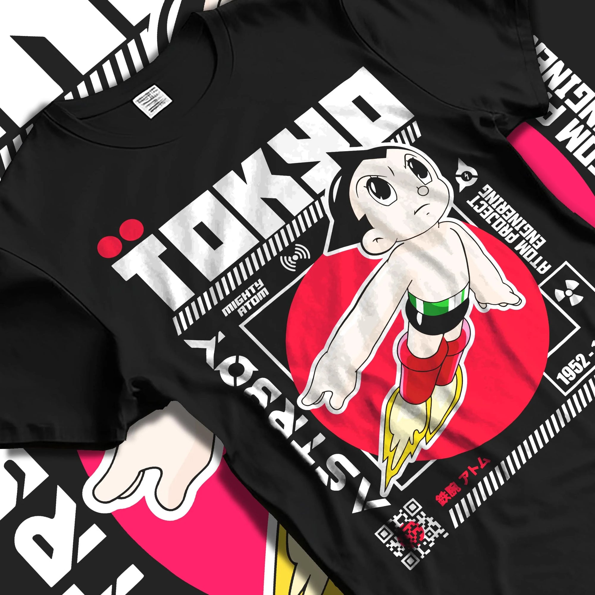 Black T-shirt laid flat with natural folds with Astro Boy Hoodie Retro Tokyo Anime Robot Hero Poster graphic bold anime graphic.