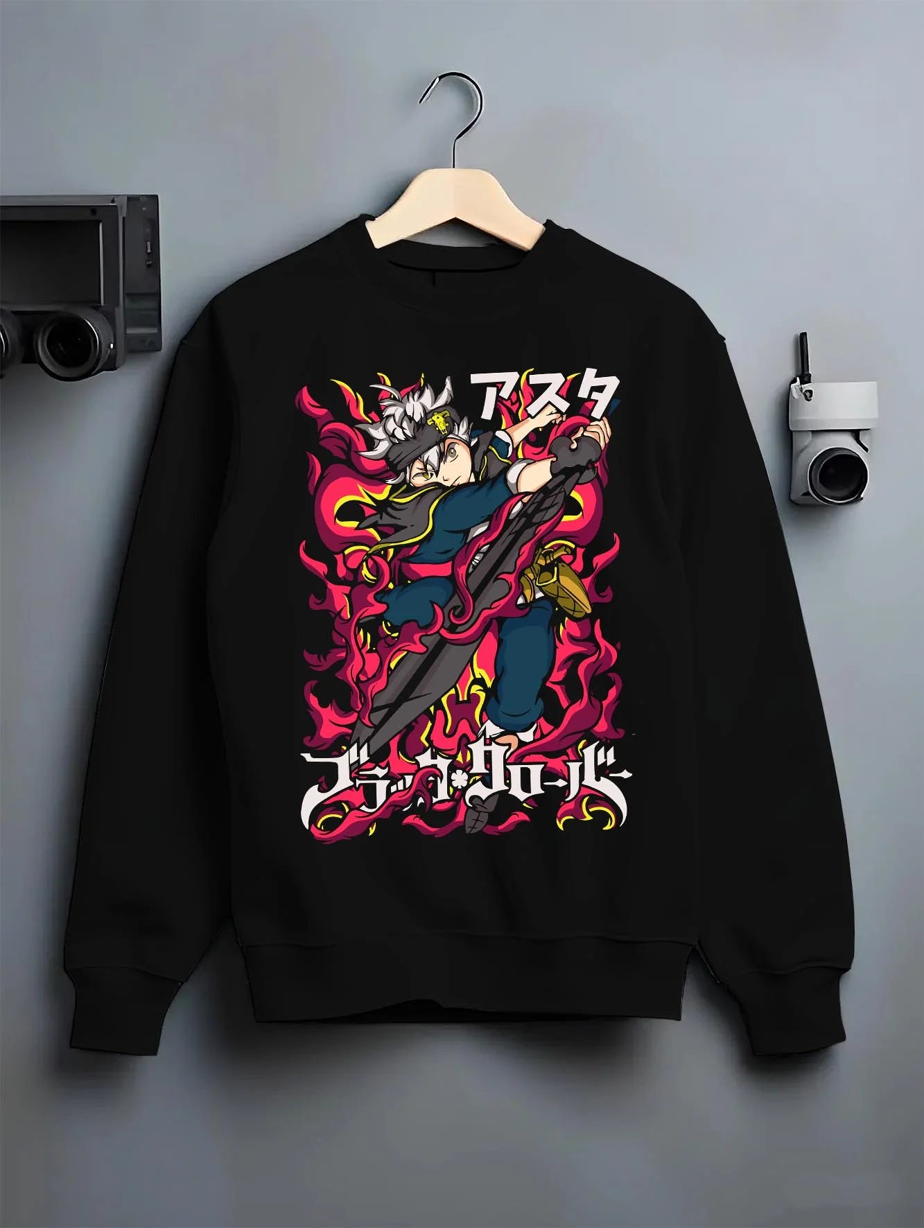 Black crewneck sweatshirt on hanger with Asta Magic Sword Hoodie Black Clover Red Blade Stance graphic bold anime graphic.