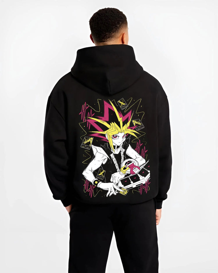 Black hoodie worn by male model from the back featuring Atem and Dark Magician Yu-Gi-Oh duel spirit artwork.