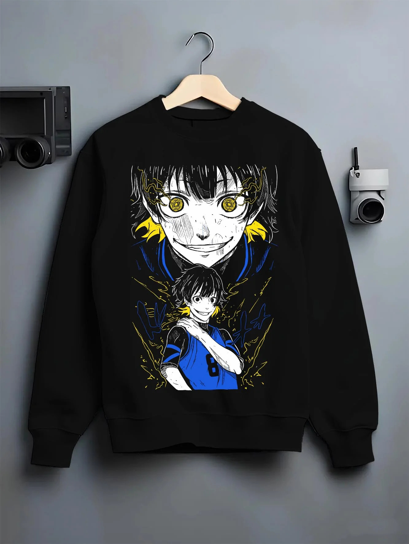 Black crewneck sweatshirt on hanger with Bachi Hoodie Blue Lock Intense Yellow Eyes Stare Down graphic bold anime graphic.