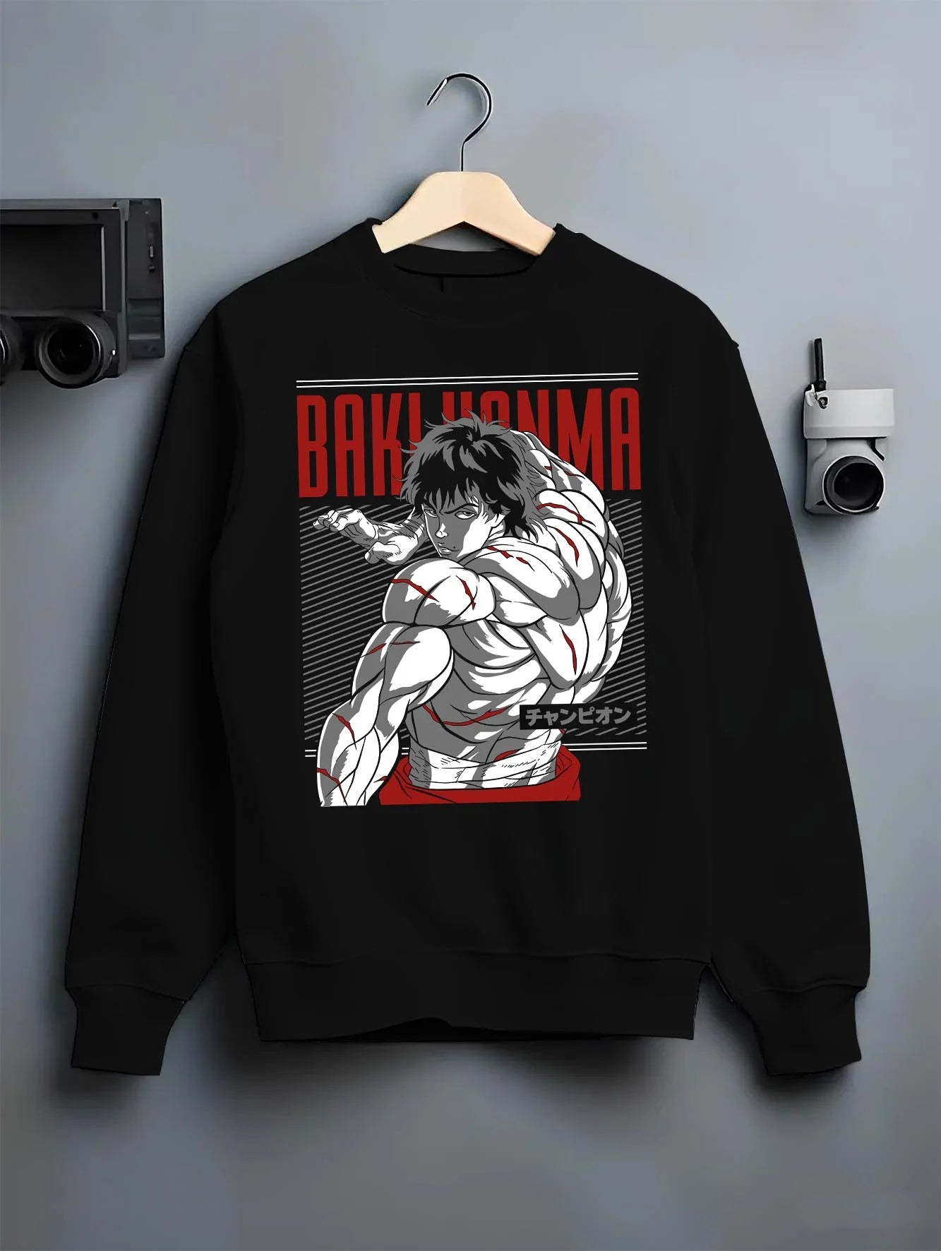 Black crewneck sweatshirt on hanger with Baki Hanma Hoodie Grappler Baki Martial Arts Fighter graphic premium wear.