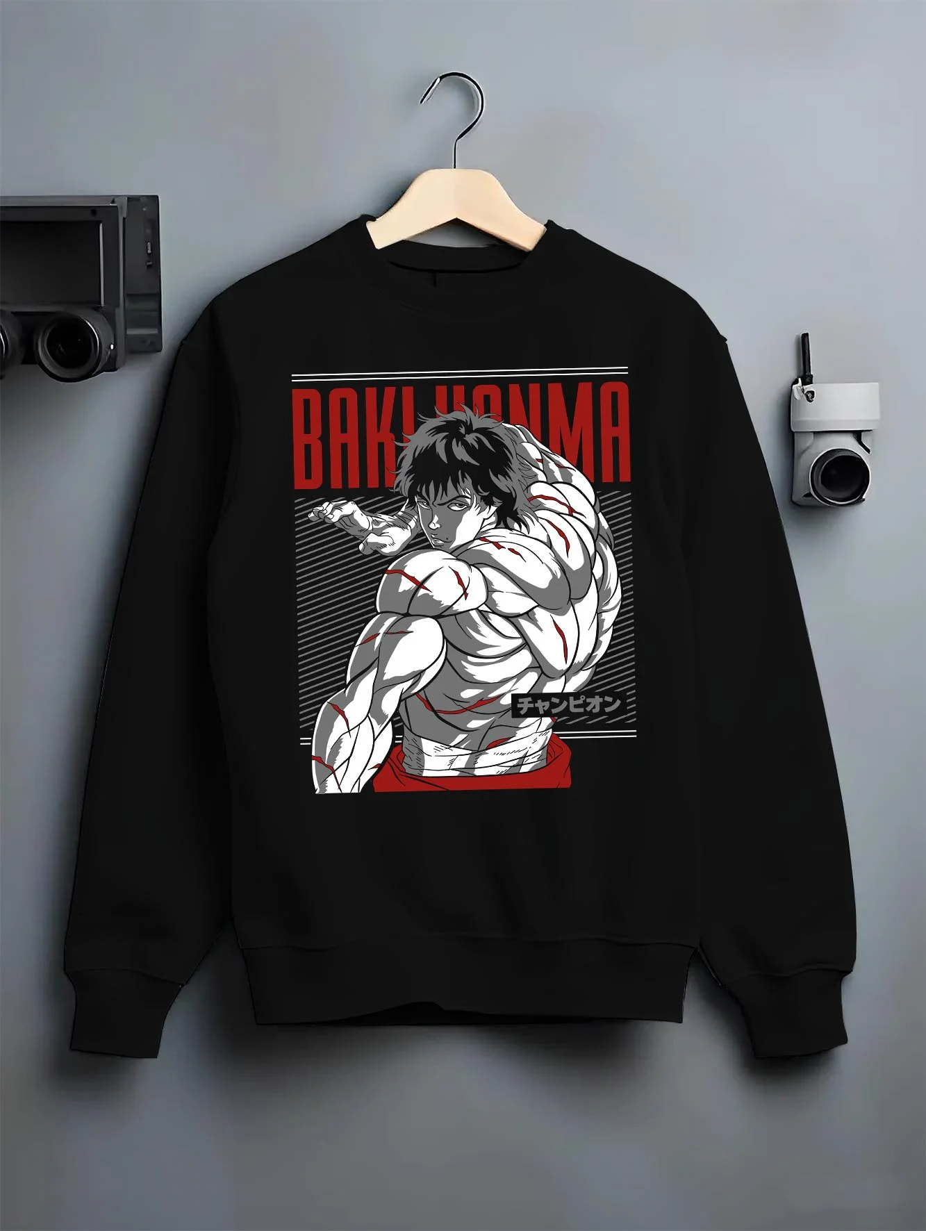 Black crewneck sweatshirt on hanger with Baki Hanma Hoodie Grappler Baki Martial Arts Fighter graphic premium wear.
