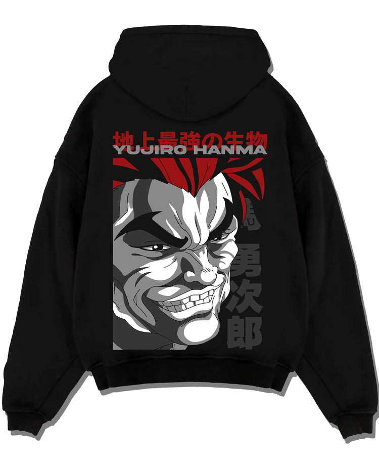 Black pullover hoodie laid flat with Yujiro Hanma Hoodie Baki the Grappler Fierce Grin graphic bold anime graphic.