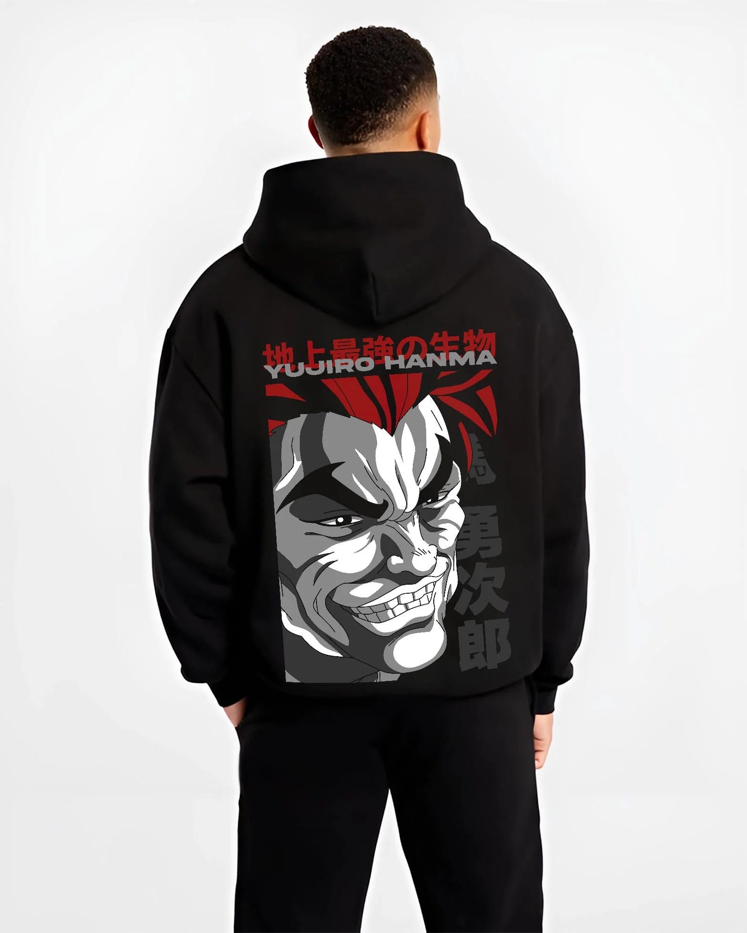 Black hoodie worn by male model, back view with Yujiro Hanma Hoodie Baki the Grappler Fierce Grin graphic premium wear.