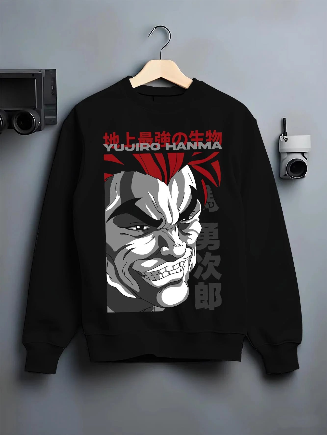 Black crewneck sweatshirt on hanger with Yujiro Hanma Hoodie Baki the Grappler Fierce Grin graphic premium wear.