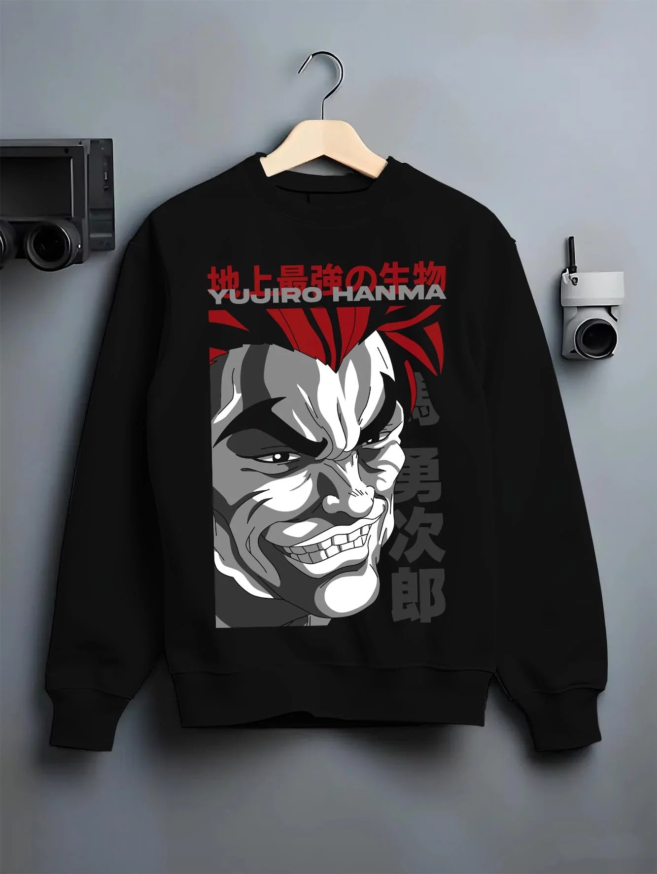 Black crewneck sweatshirt on hanger with Yujiro Hanma Hoodie Baki the Grappler Fierce Grin graphic premium wear.