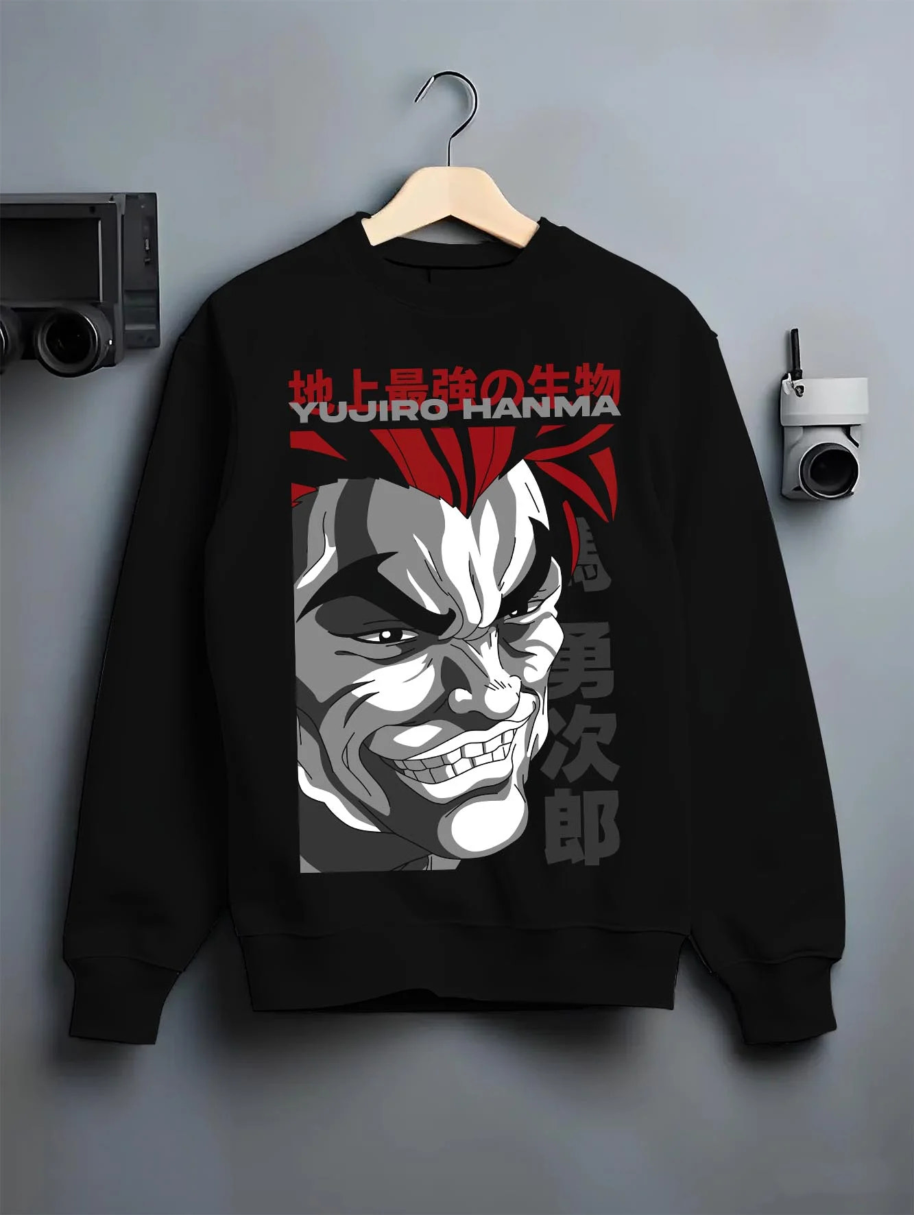 Black crewneck sweatshirt on hanger with Yujiro Hanma Hoodie Baki the Grappler Fierce Grin graphic premium wear.