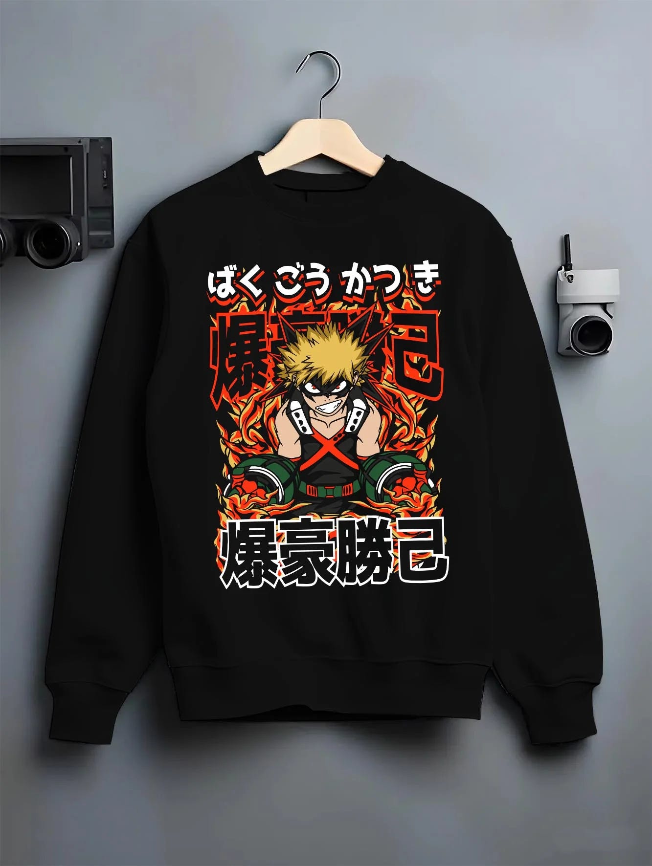 Black crewneck sweatshirt on hanger with Bakugo Explosion Hoodie My Hero Academia Blazing Rage graphic bold anime graphic.