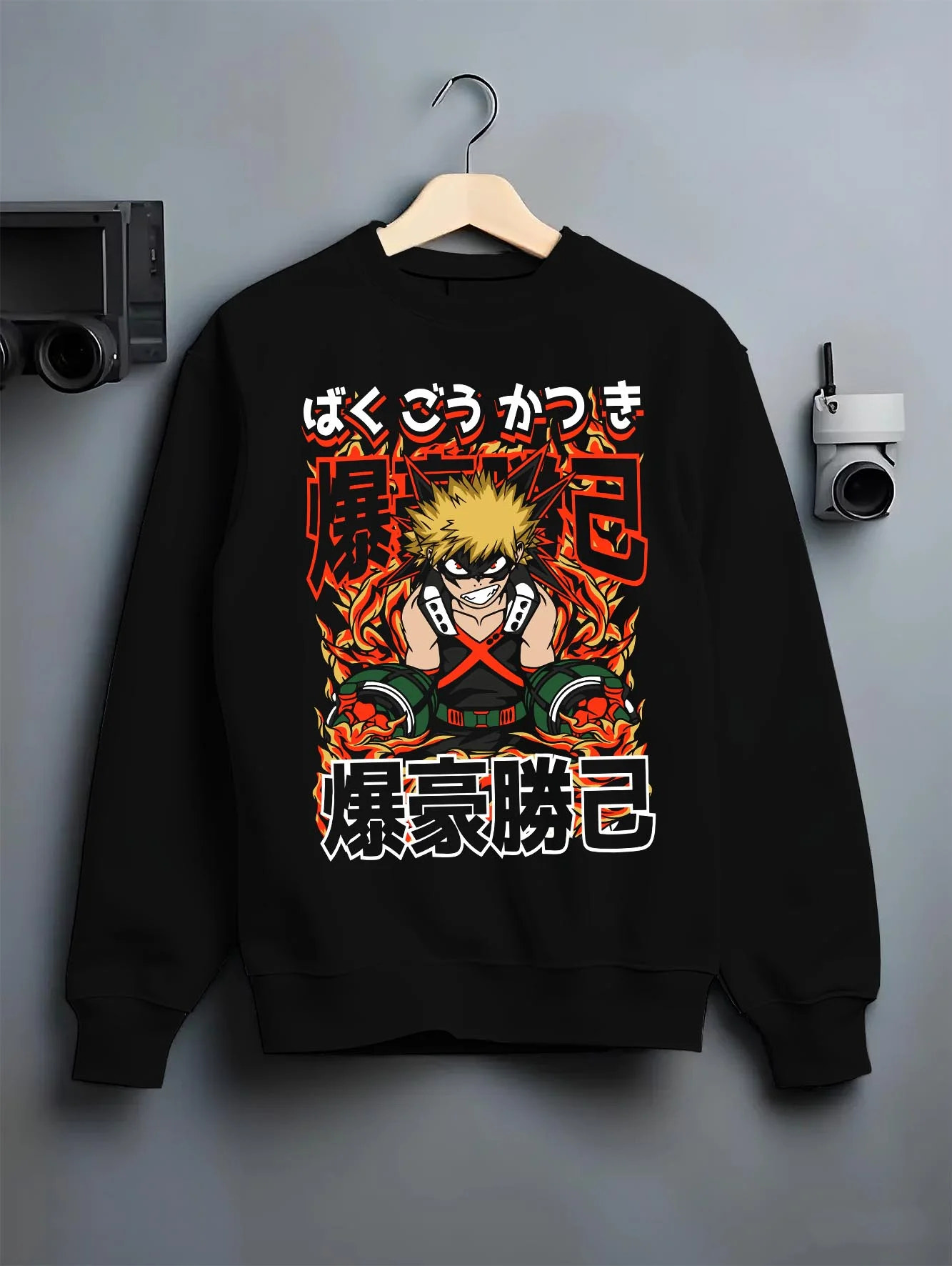 Black crewneck sweatshirt on hanger with Bakugo Explosion Hoodie My Hero Academia Blazing Rage graphic bold anime graphic.