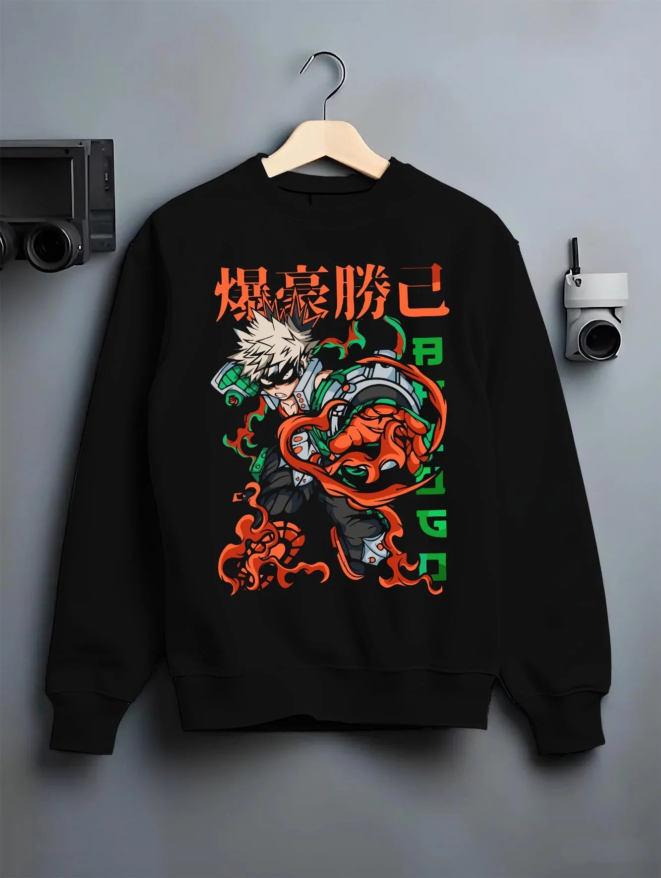Black crewneck sweatshirt on hanger with Bakugo Power Hoodie My Hero Academia Inferno Battle graphic premium wear.