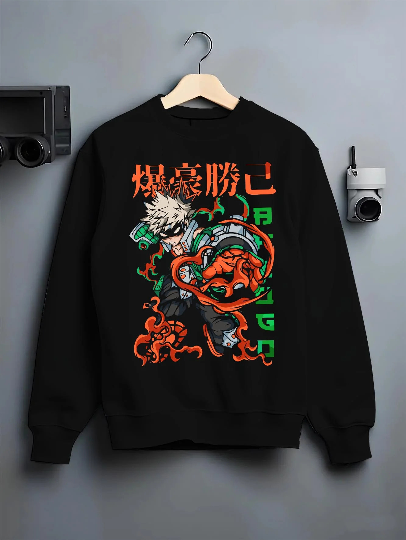 Black crewneck sweatshirt on hanger with Bakugo Power Hoodie My Hero Academia Inferno Battle graphic premium wear.