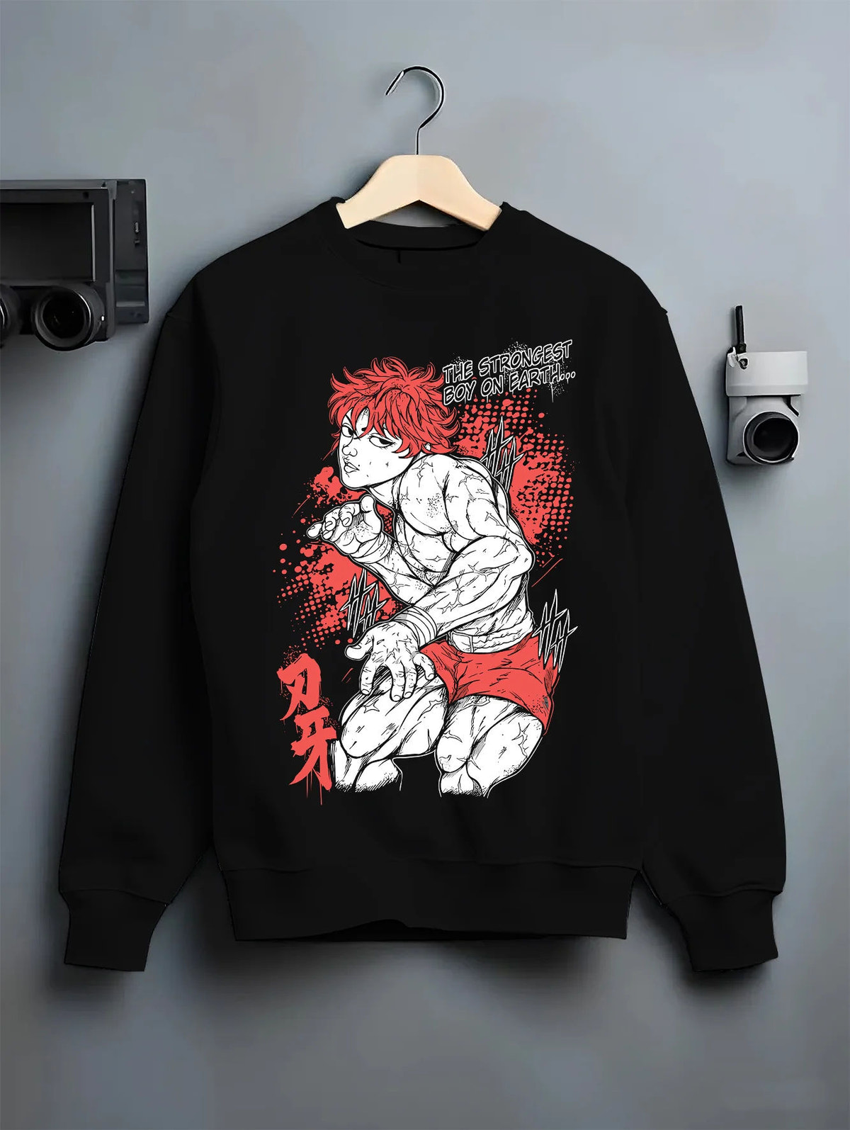 Black crewneck sweatshirt on hanger showing Baki Hanma: crouched fighting pose