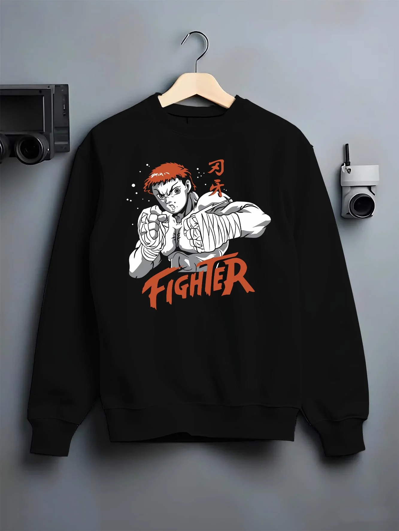 Black crewneck sweatshirt on hanger with Baki Hanma Hoodie Grappler Baki Fighter Ring Stance graphic premium wear.