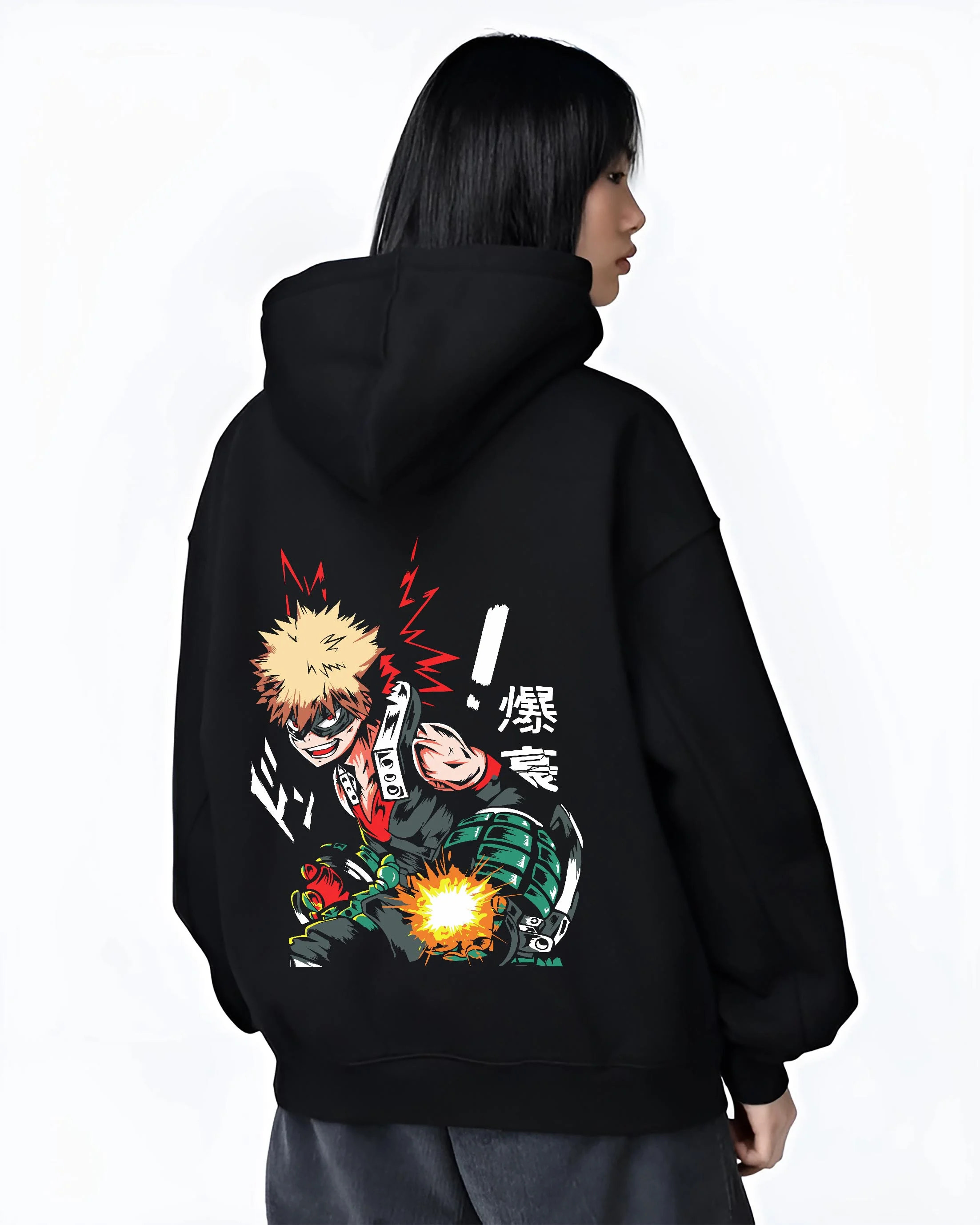 Black hoodie worn by female model, back view with Bakugo Hero Hoodie My Hero Academia Green Blast Scene graphic bold anime graphic.