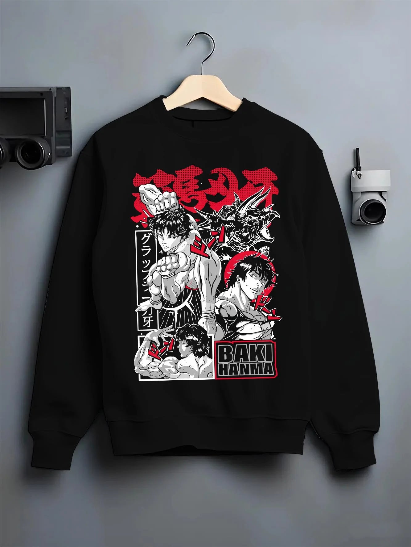 Black crewneck sweatshirt on hanger with Baki vs Bakugo Hoodie Crossover Hero Fighting Poster graphic bold anime graphic.