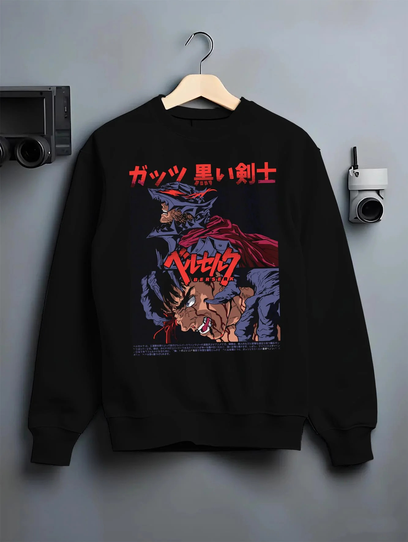 Black crewneck sweatshirt on hanger with Berserk Guts Hoodie Dark Swordsman Bloody Poster graphic streetwear graphic.