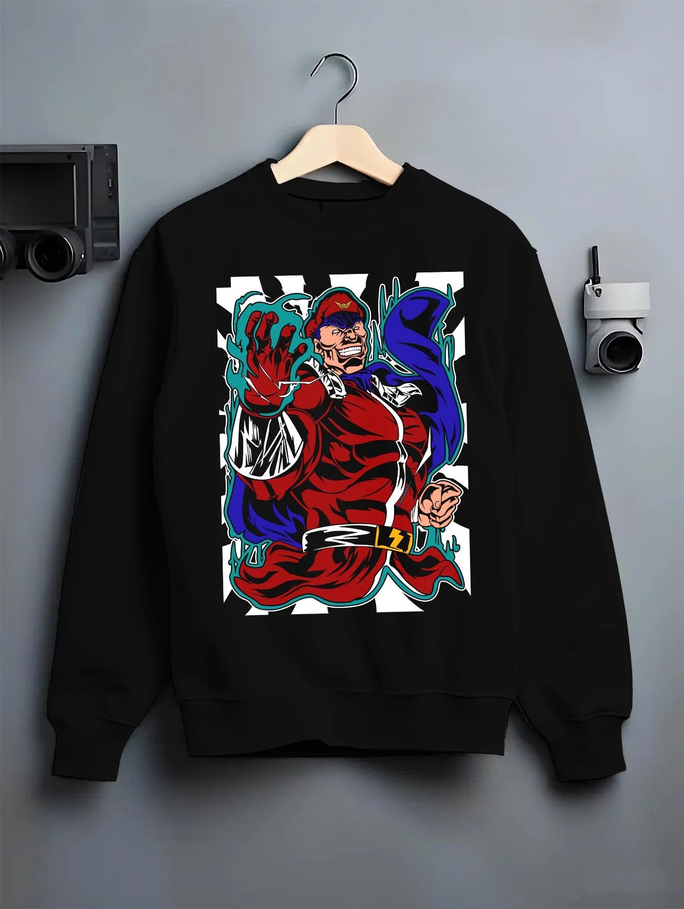Black crewneck sweatshirt on hanger with M. Bison Hoodie Street Fighter Psycho Power Pose graphic streetwear graphic.