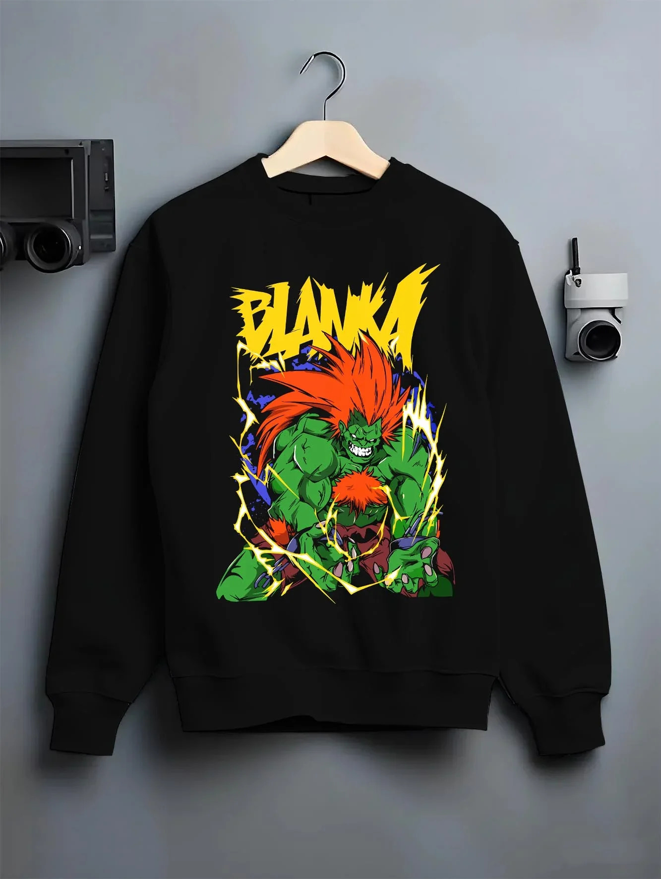 Black crewneck sweatshirt on hanger with Blanka Hoodie Street Fighter Green Beast Retro Roar graphic bold anime graphic.