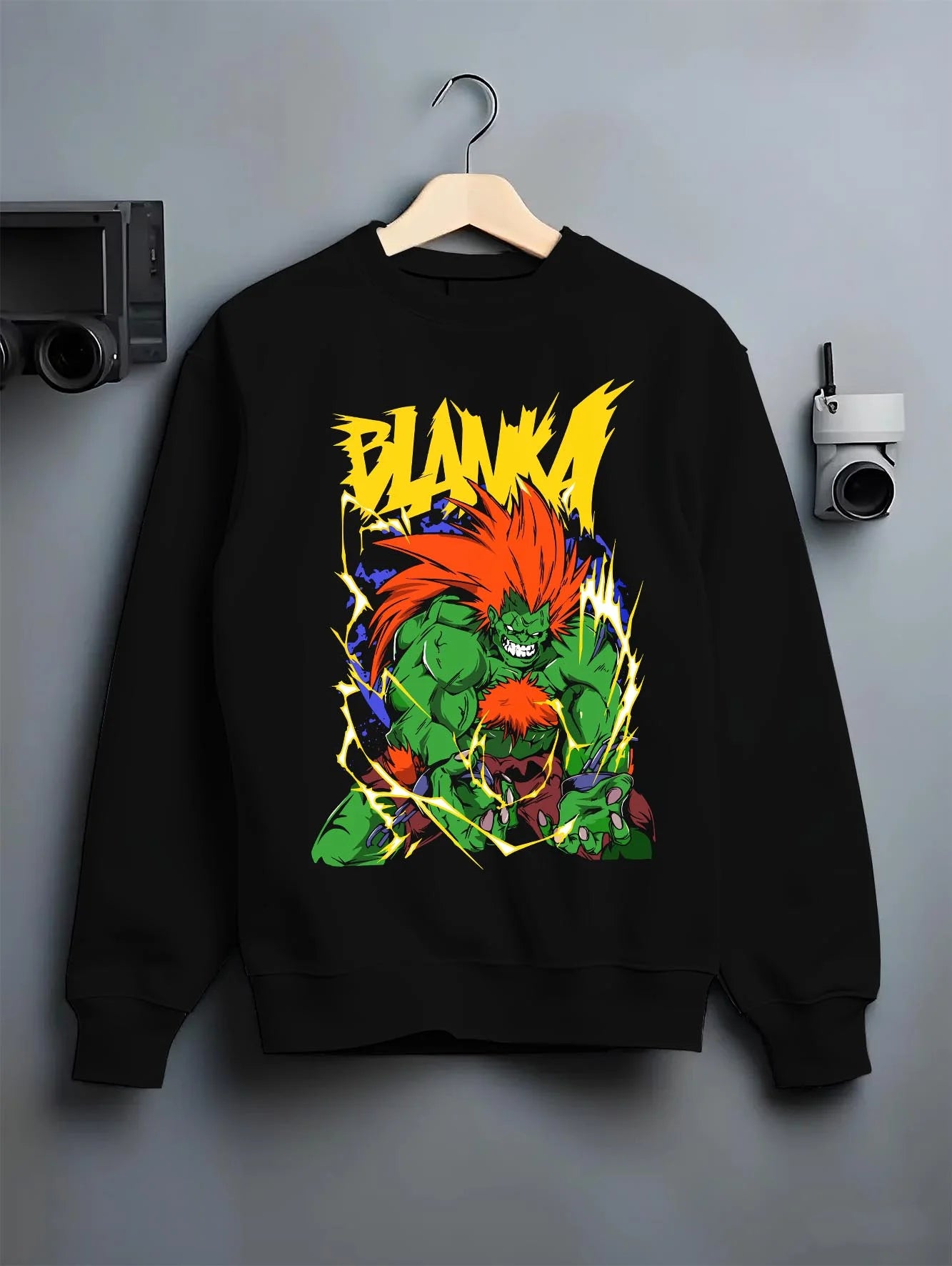 Black crewneck sweatshirt on hanger with Blanka Hoodie Street Fighter Green Beast Retro Roar graphic bold anime graphic.