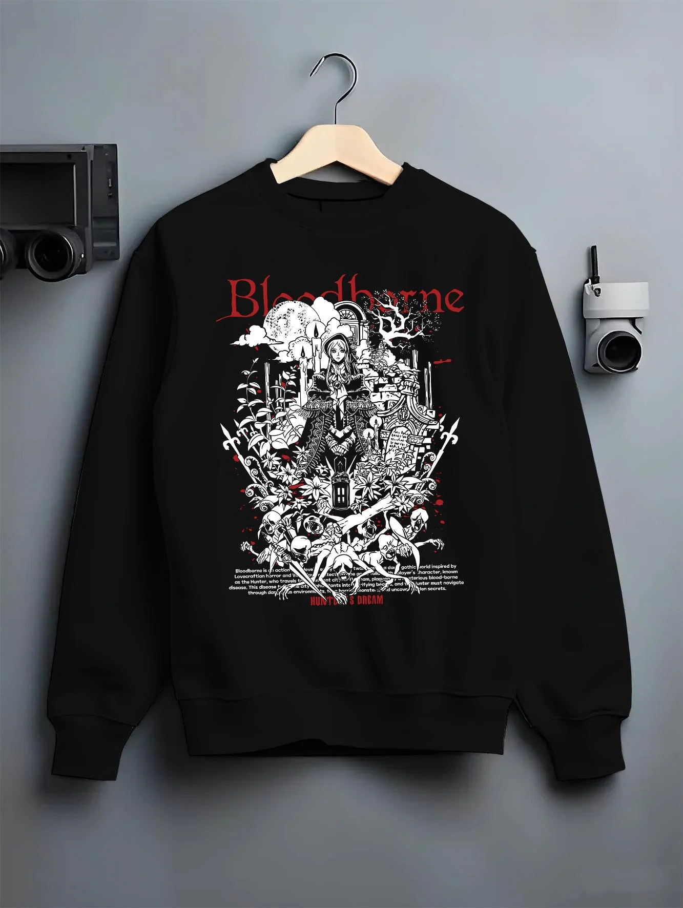 Black crewneck sweatshirt on hanger with Bloodborne Hoodie Gothic Hunter Dark Fantasy Poster graphic premium wear.