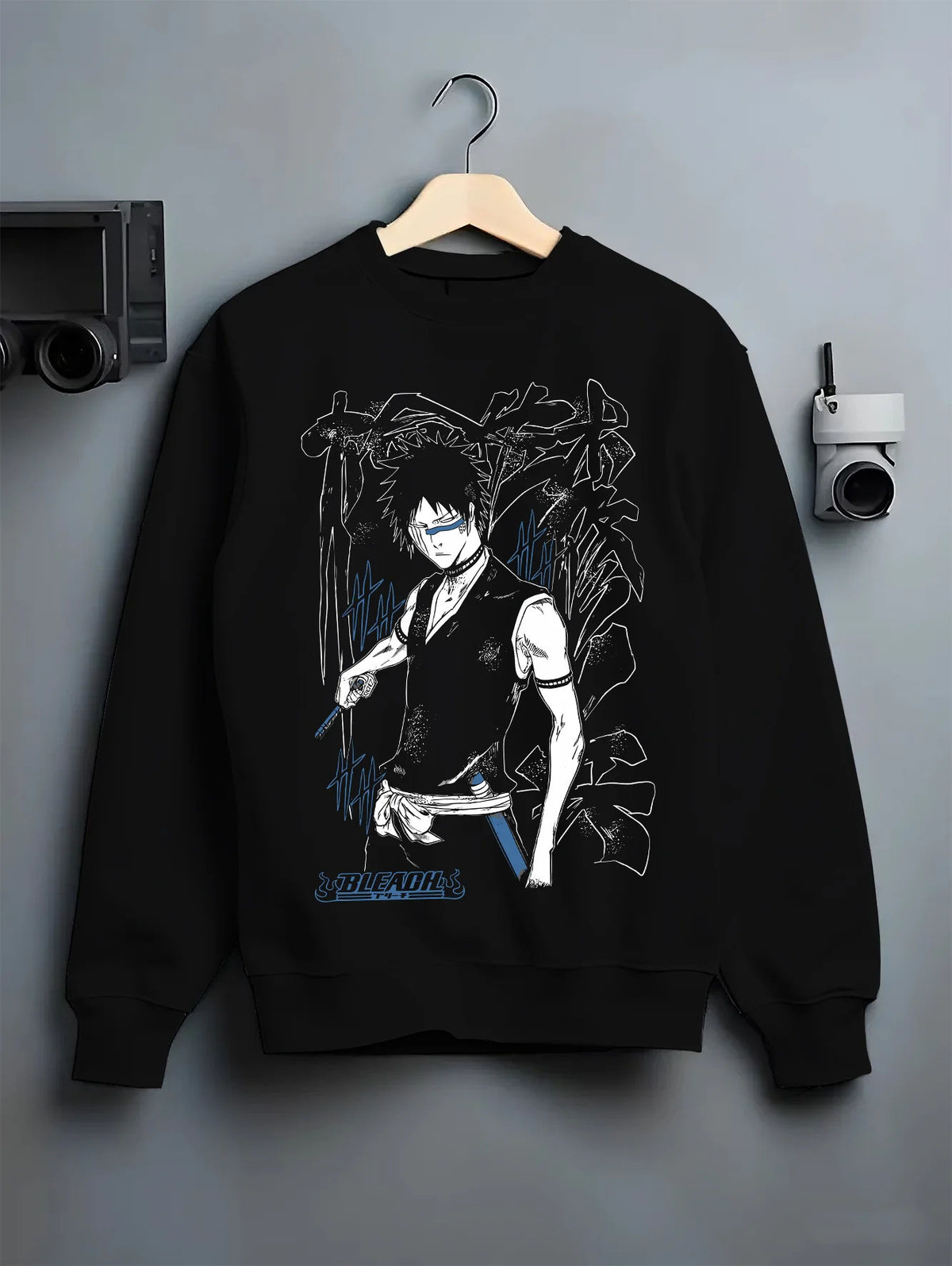 Black crewneck sweatshirt on hanger showing Bleach: dark-haired swordsman with sword
