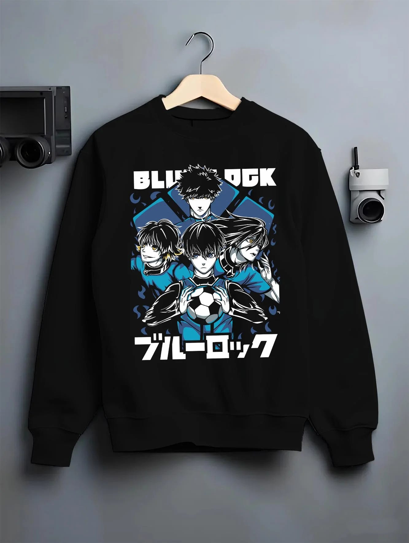 Black crewneck sweatshirt on hanger with Blue Lock Hoodie Japan Soccer Team Trio Panel Print graphic premium wear.