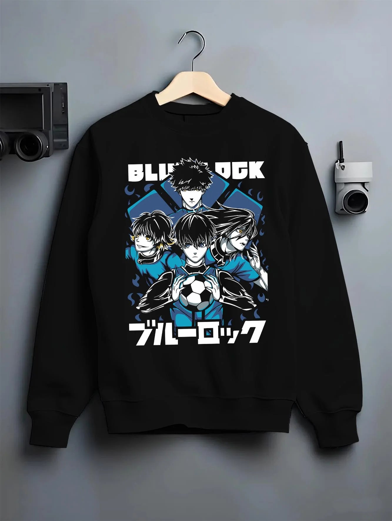 Black crewneck sweatshirt on hanger with Blue Lock Hoodie Japan Soccer Team Trio Panel Print graphic premium wear.