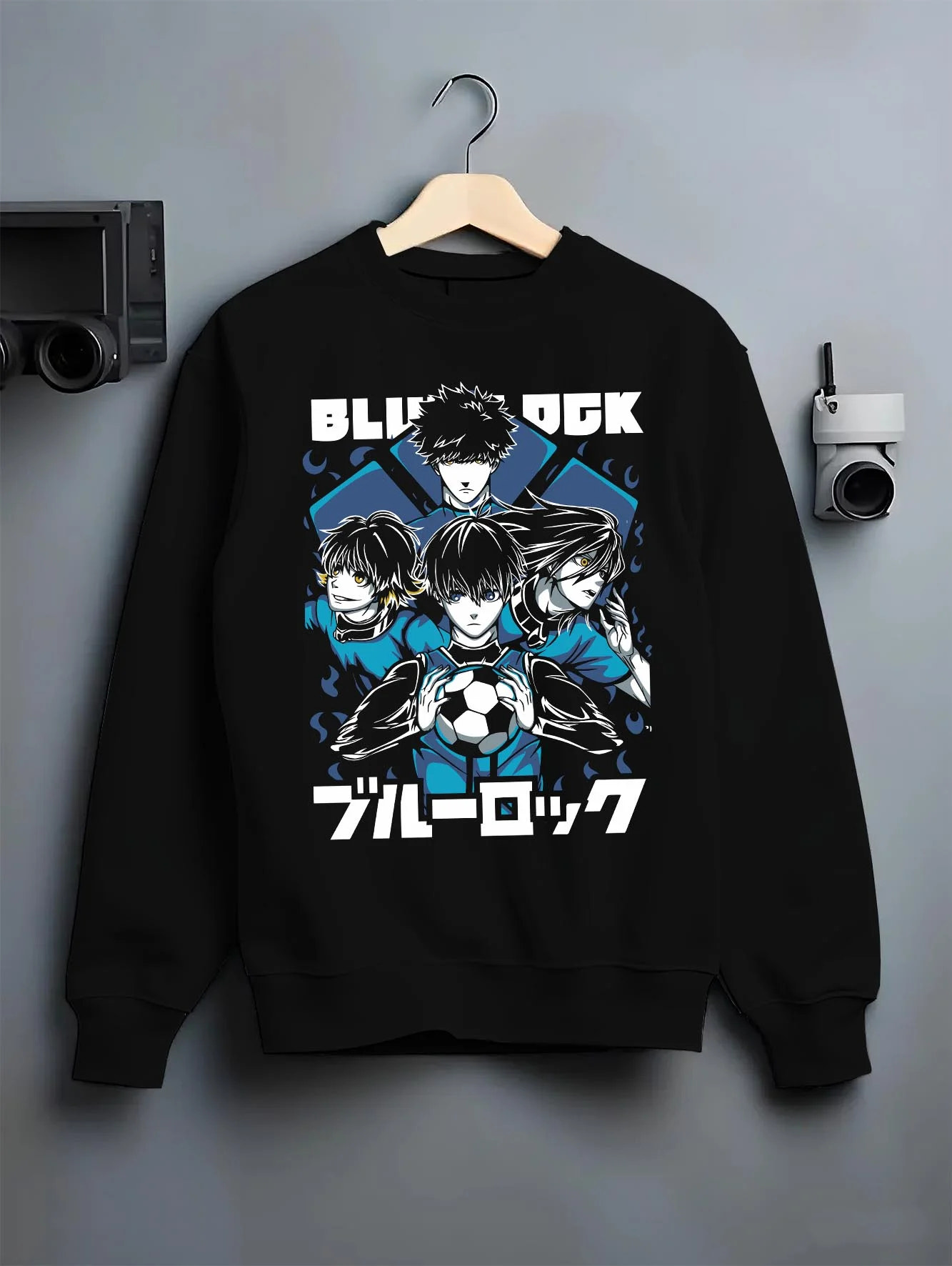 Black crewneck sweatshirt on hanger with Blue Lock Hoodie Japan Soccer Team Trio Panel Print graphic premium wear.