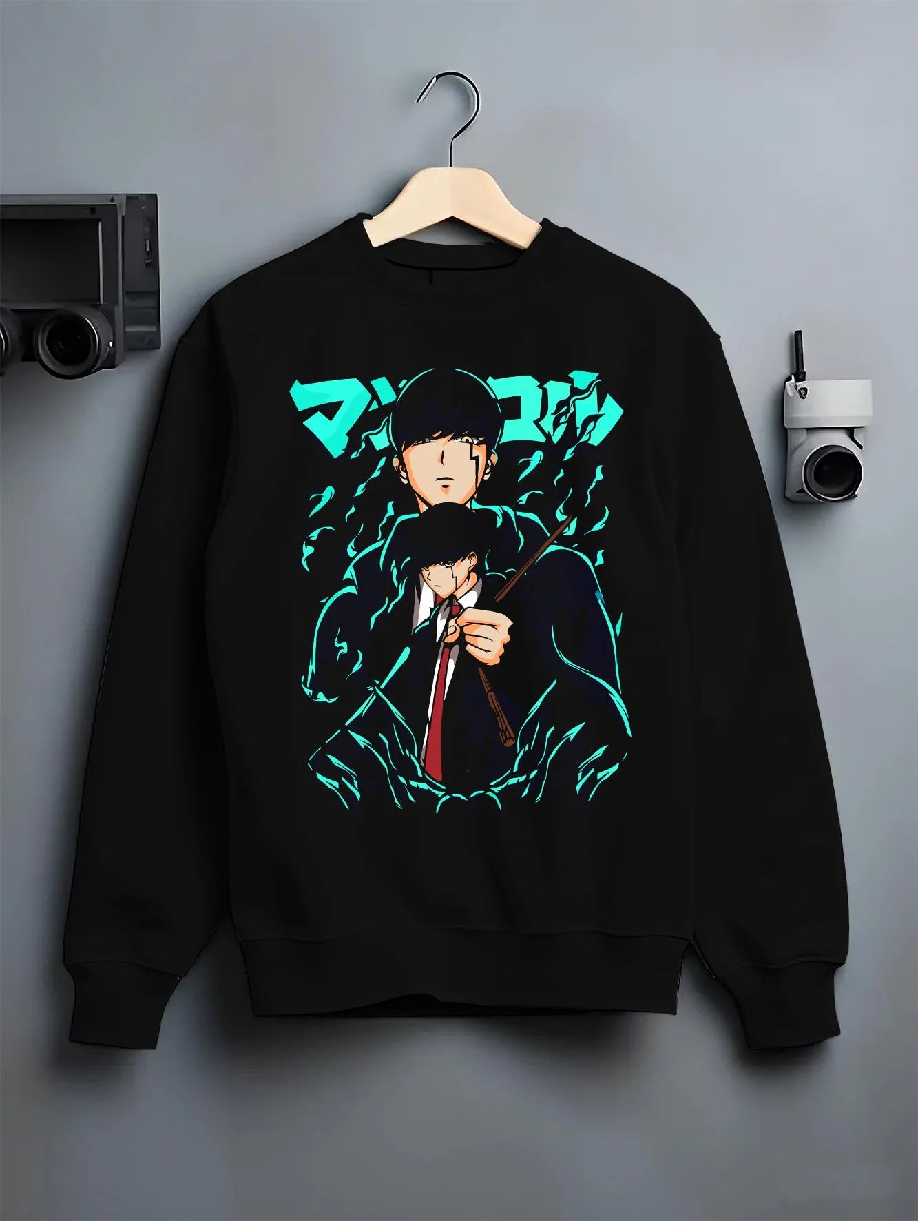 Black crewneck sweatshirt on hanger with Mashle Magic Muscles Hoodie Blue Dynamic Jumper graphic bold anime graphic.