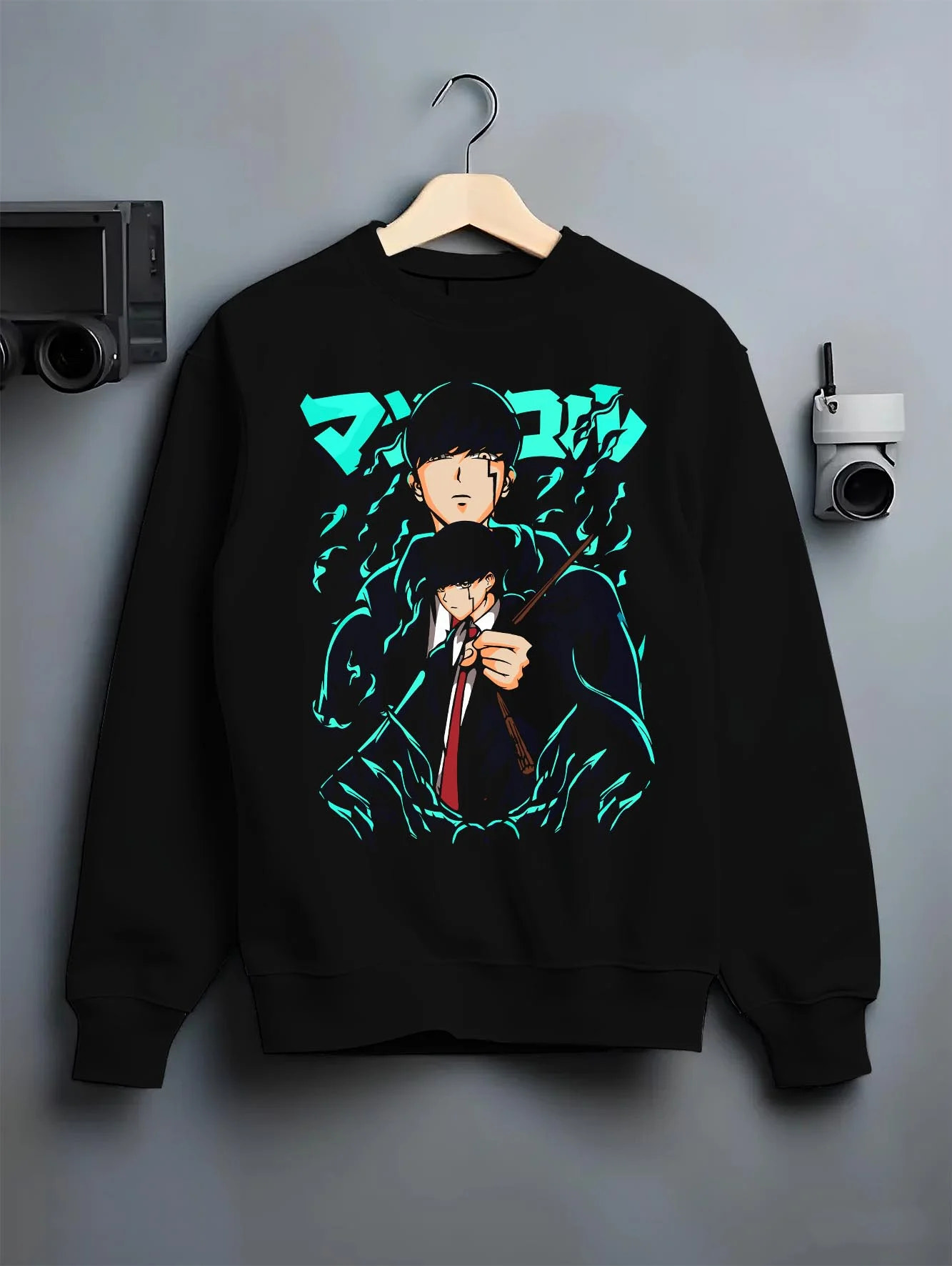 Black crewneck sweatshirt on hanger with Mashle Magic Muscles Hoodie Blue Dynamic Jumper graphic bold anime graphic.