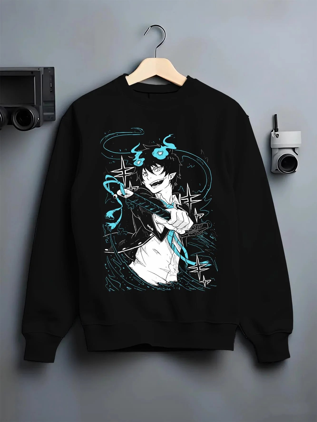 Black crewneck sweatshirt on hanger featuring Rin Okumura Blue Exorcist dark manga panel artwork with stylised character outline and retro streetwear graphic.