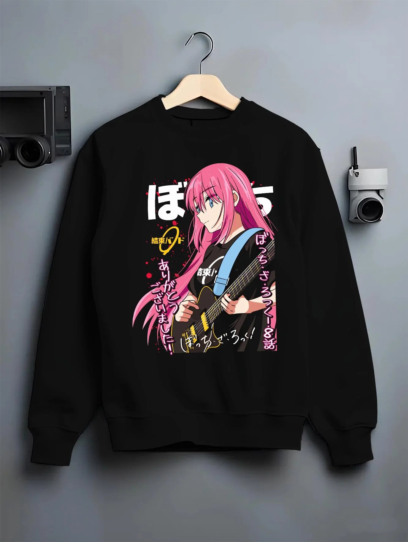 Black crewneck sweatshirt on hanger with Bocchi the Rock Hoodie Anime Guitar Shy Idol Scene graphic premium wear.
