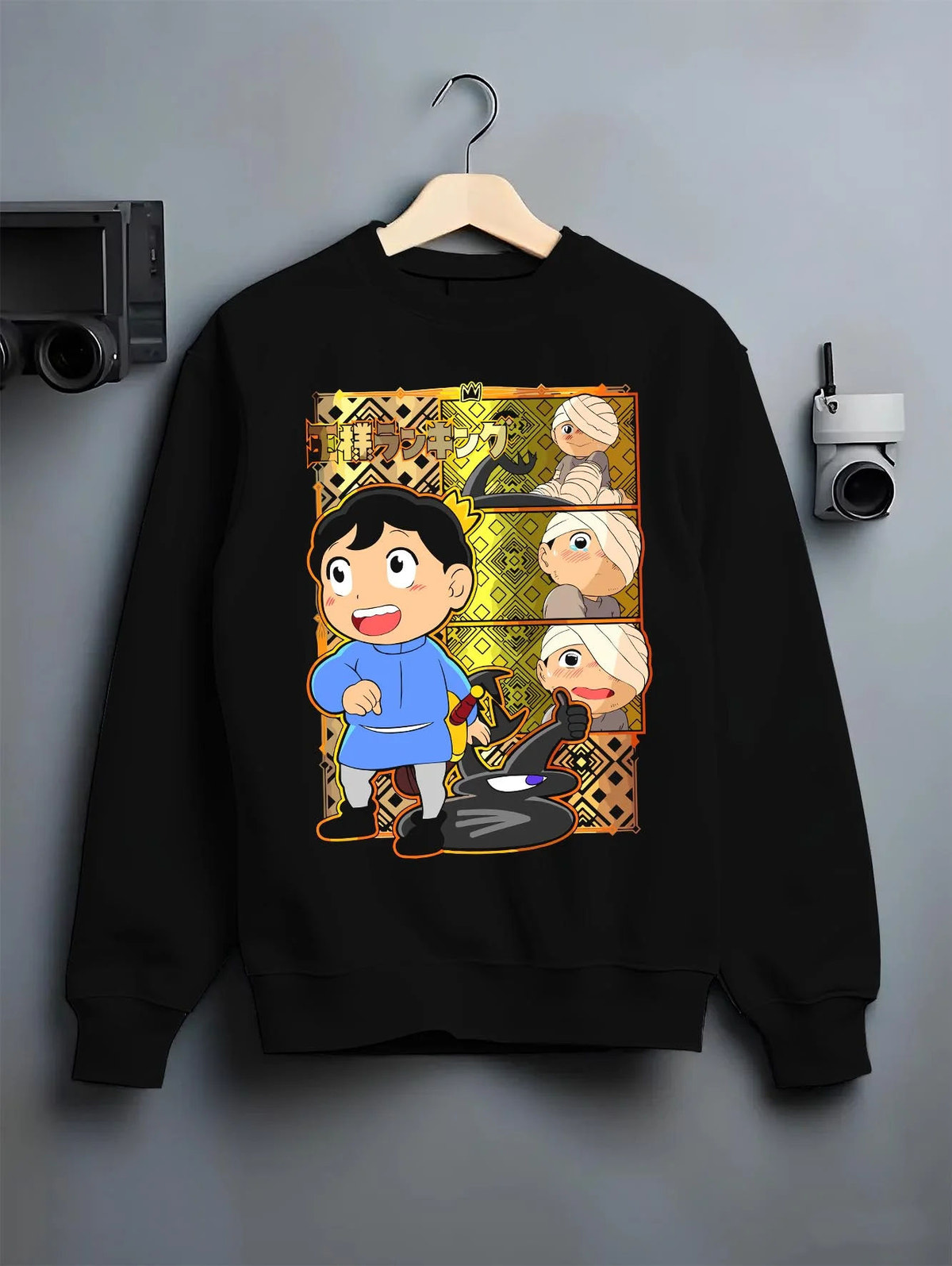 Black crewneck sweatshirt on hanger featuring Bojji and Kage Ranking of Kings artwork.