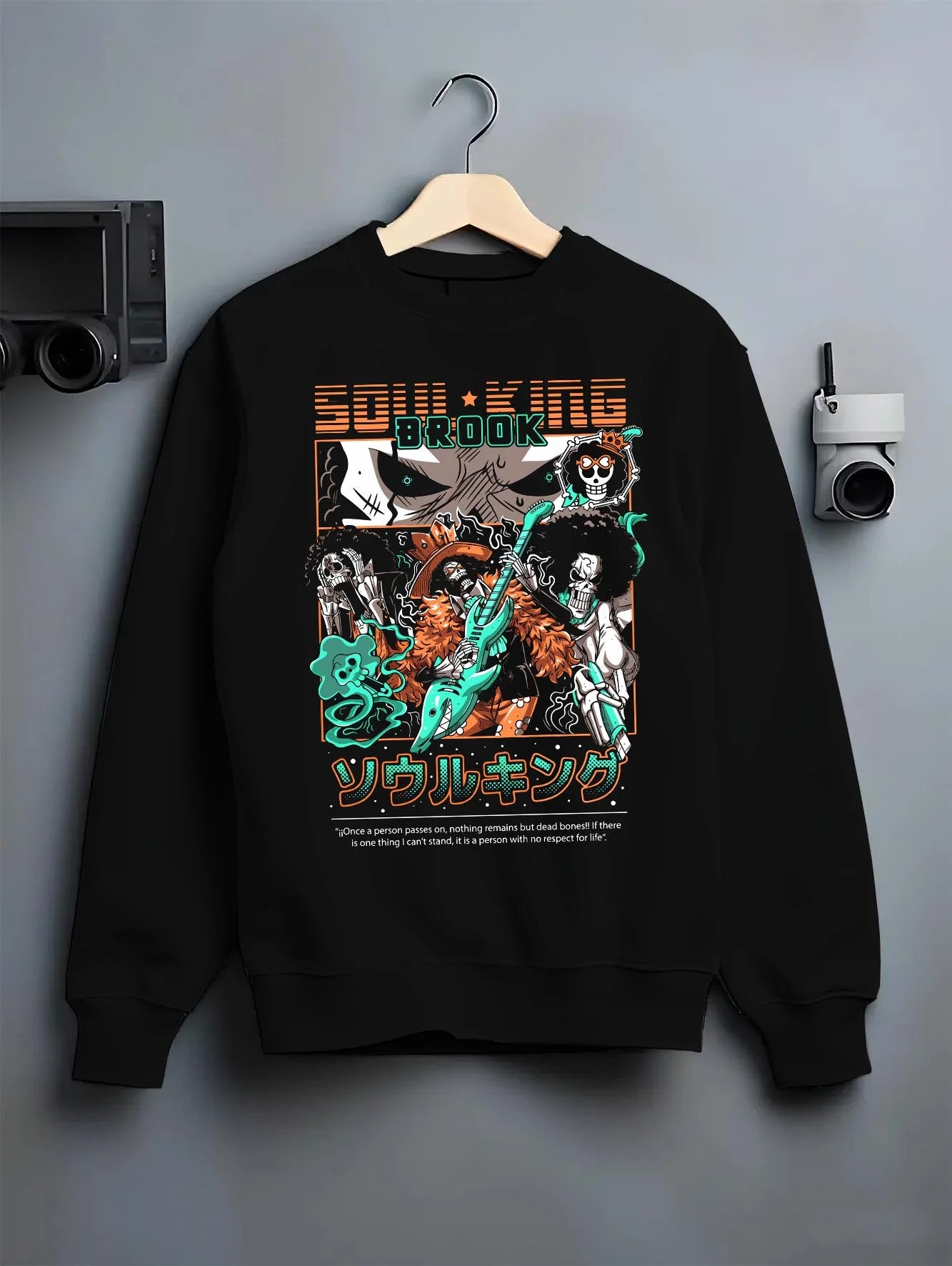 Black crewneck sweatshirt on hanger with Brook Soul King Hoodie One Piece Flame Music Scene graphic streetwear graphic.