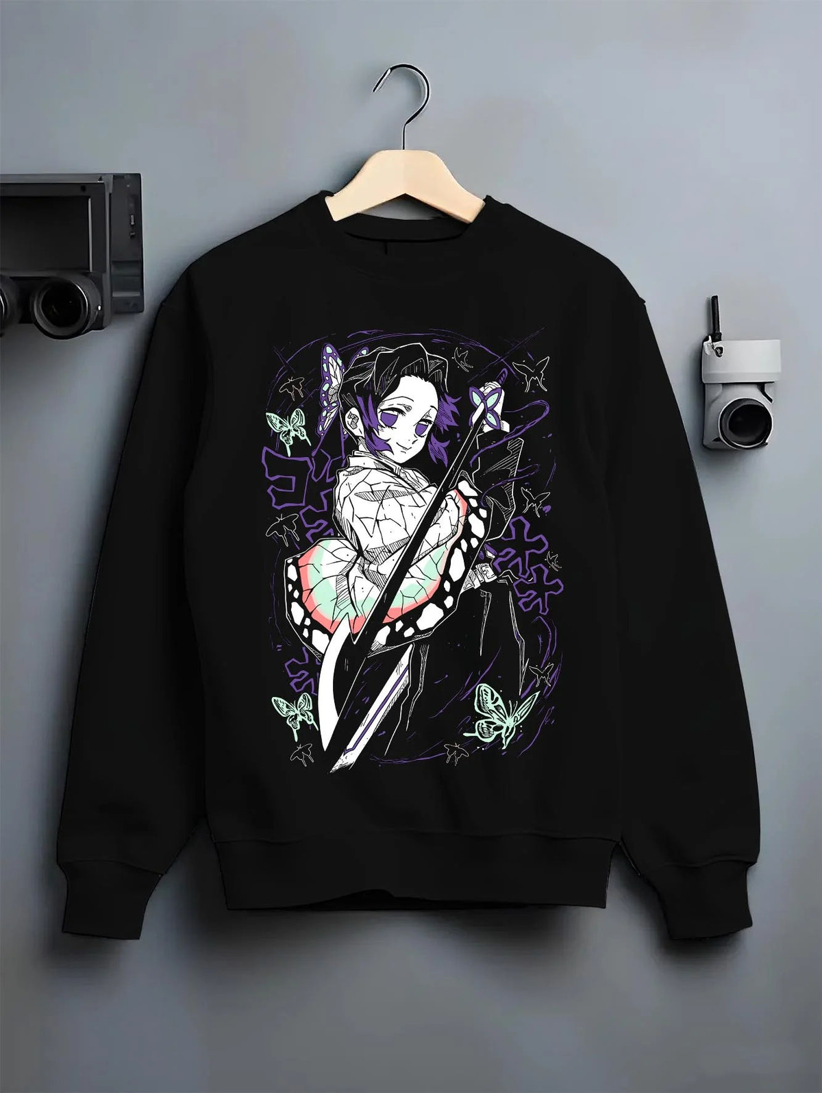 Black crewneck sweatshirt on hanger featuring Shinobu Kocho Butterfly Dance Demon Slayer artwork.