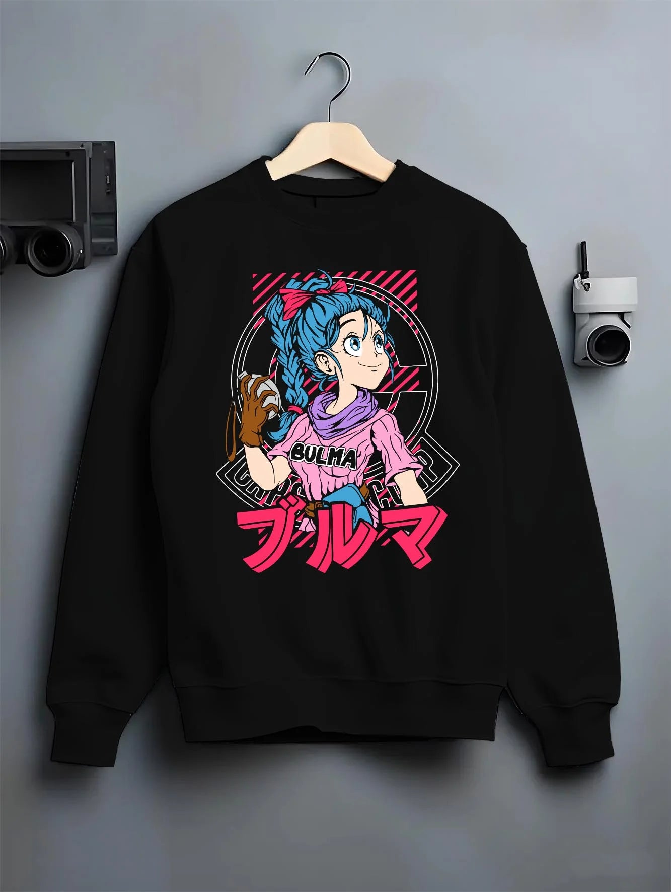 Black crewneck sweatshirt on hanger with Bulma Hoodie Dragon Ball Z Pink Outfit Capsule Corp graphic streetwear graphic.