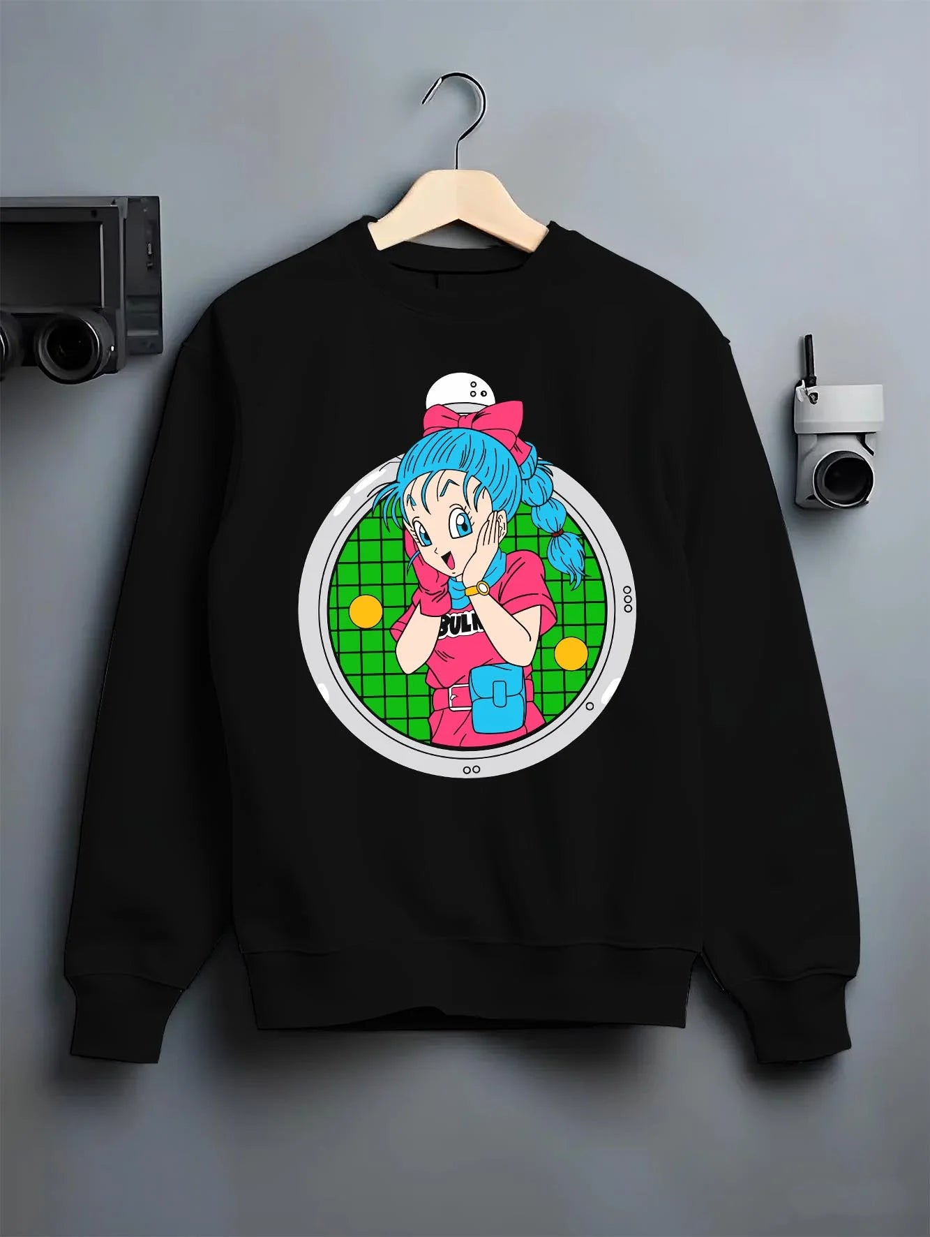 Black crewneck sweatshirt on hanger with Bulma Capsule Corp Hoodie Dragon Ball Z Retro Anime graphic streetwear graphic.