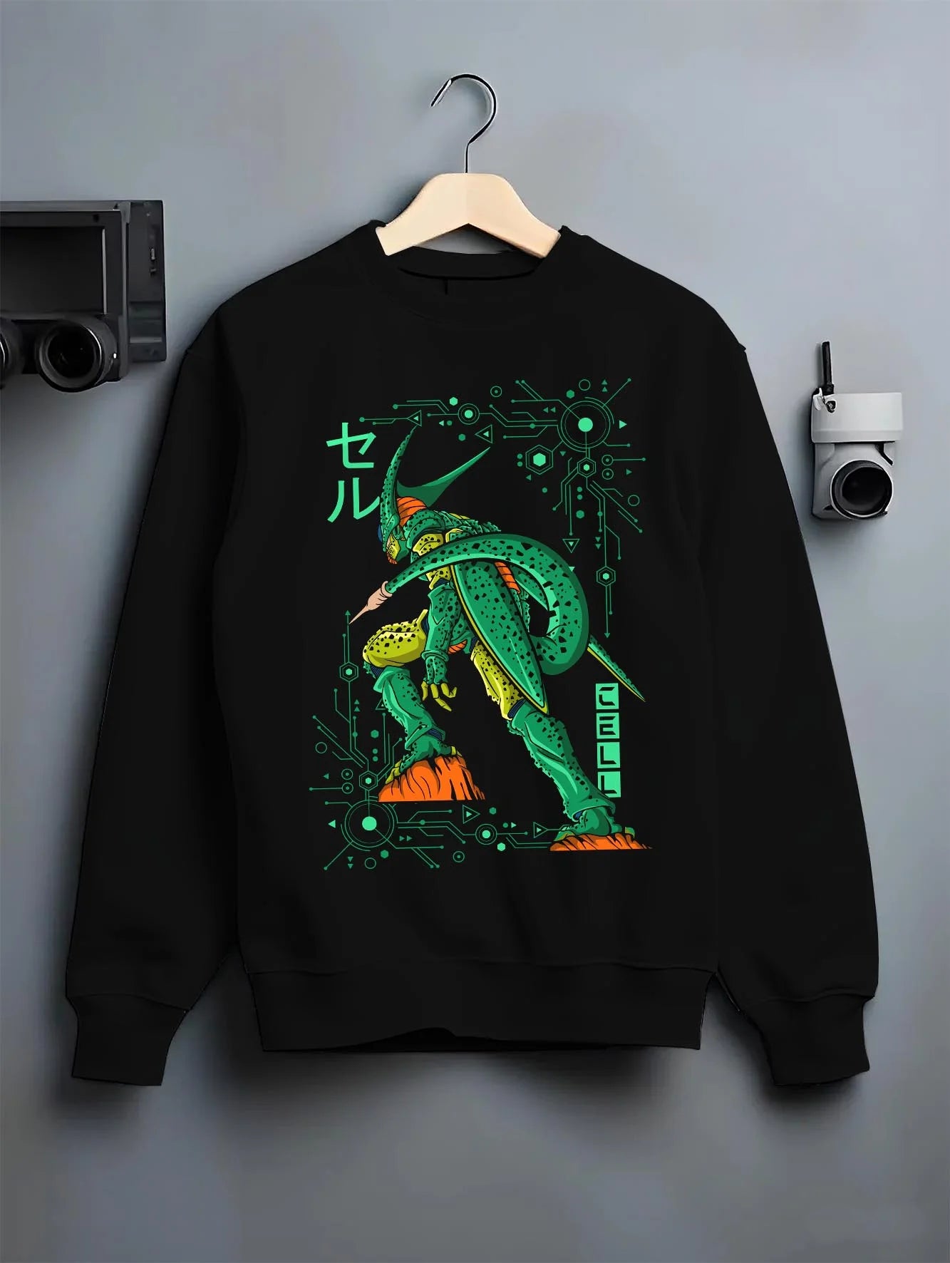 Black crewneck sweatshirt on hanger with Cell Hoodie Dragon Ball Z Perfect Villain Evolution graphic premium wear.