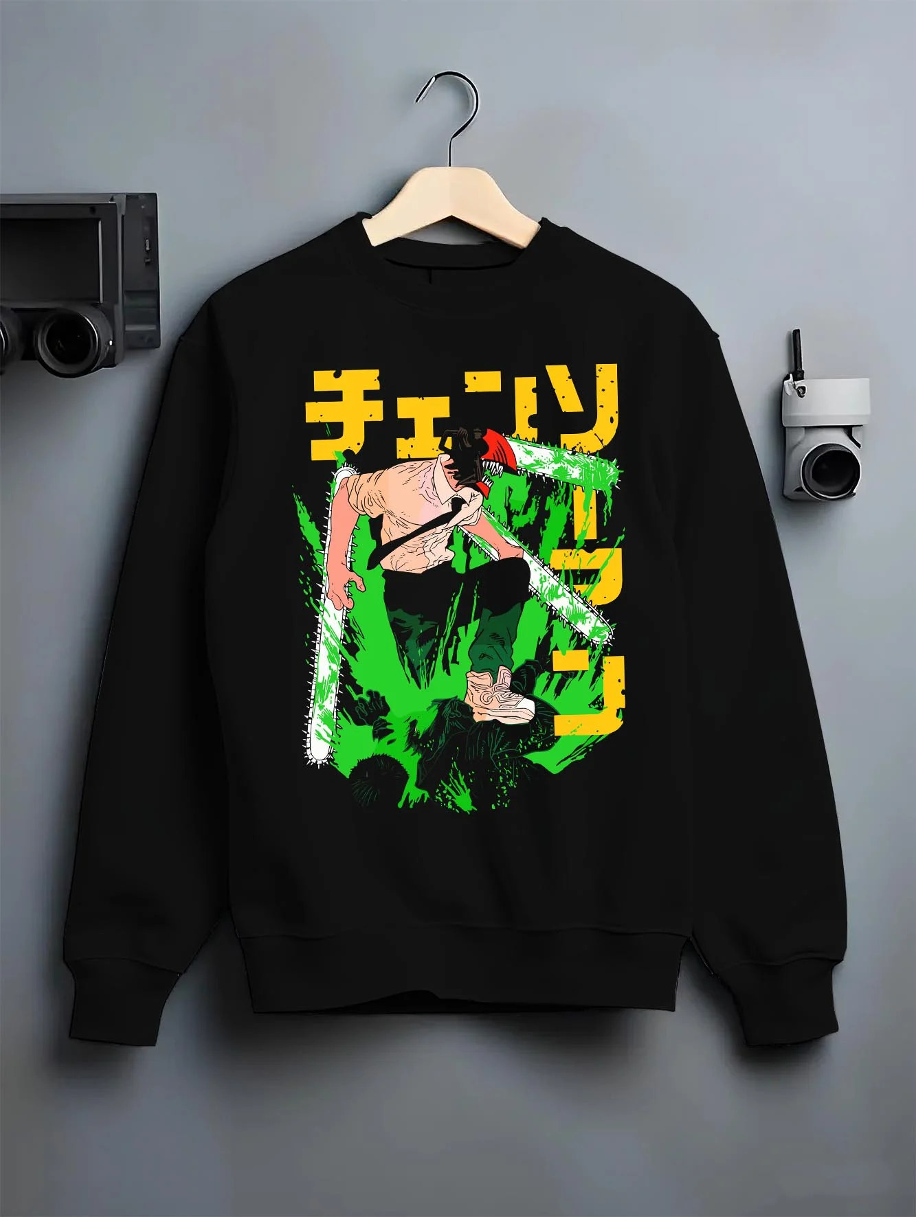 Black crewneck sweatshirt on hanger with Denji Chainsaw Man Hoodie Devil Hunter Fierce Strike graphic bold anime graphic.